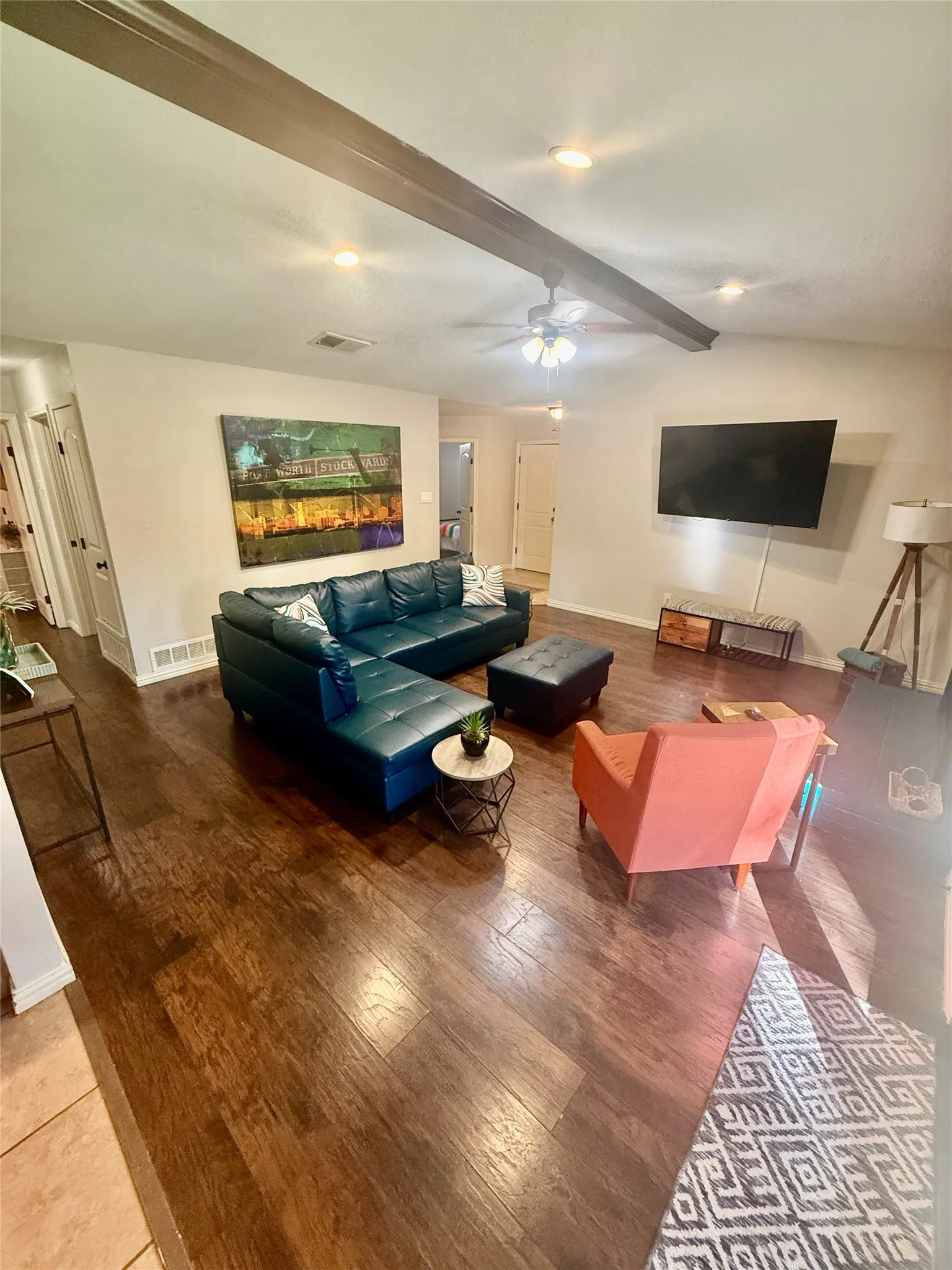 Hardwood flooring throughout, recessed lighting, and a ceiling fan