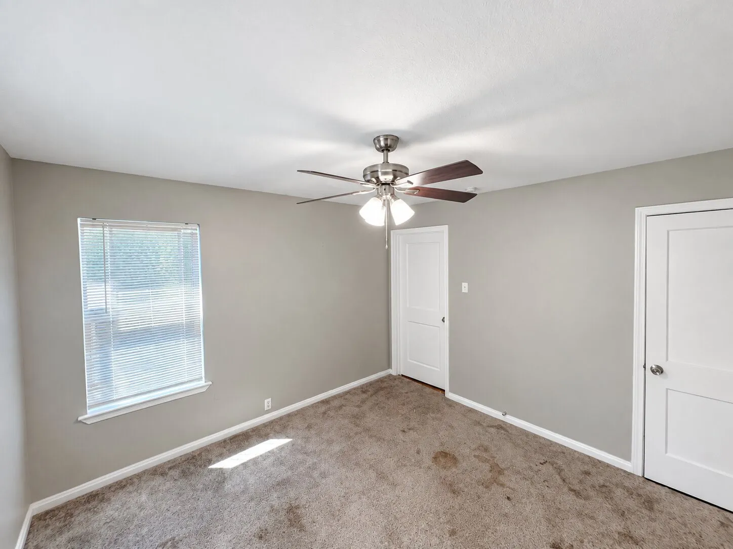 Neutral-toned walls complement plush carpeting