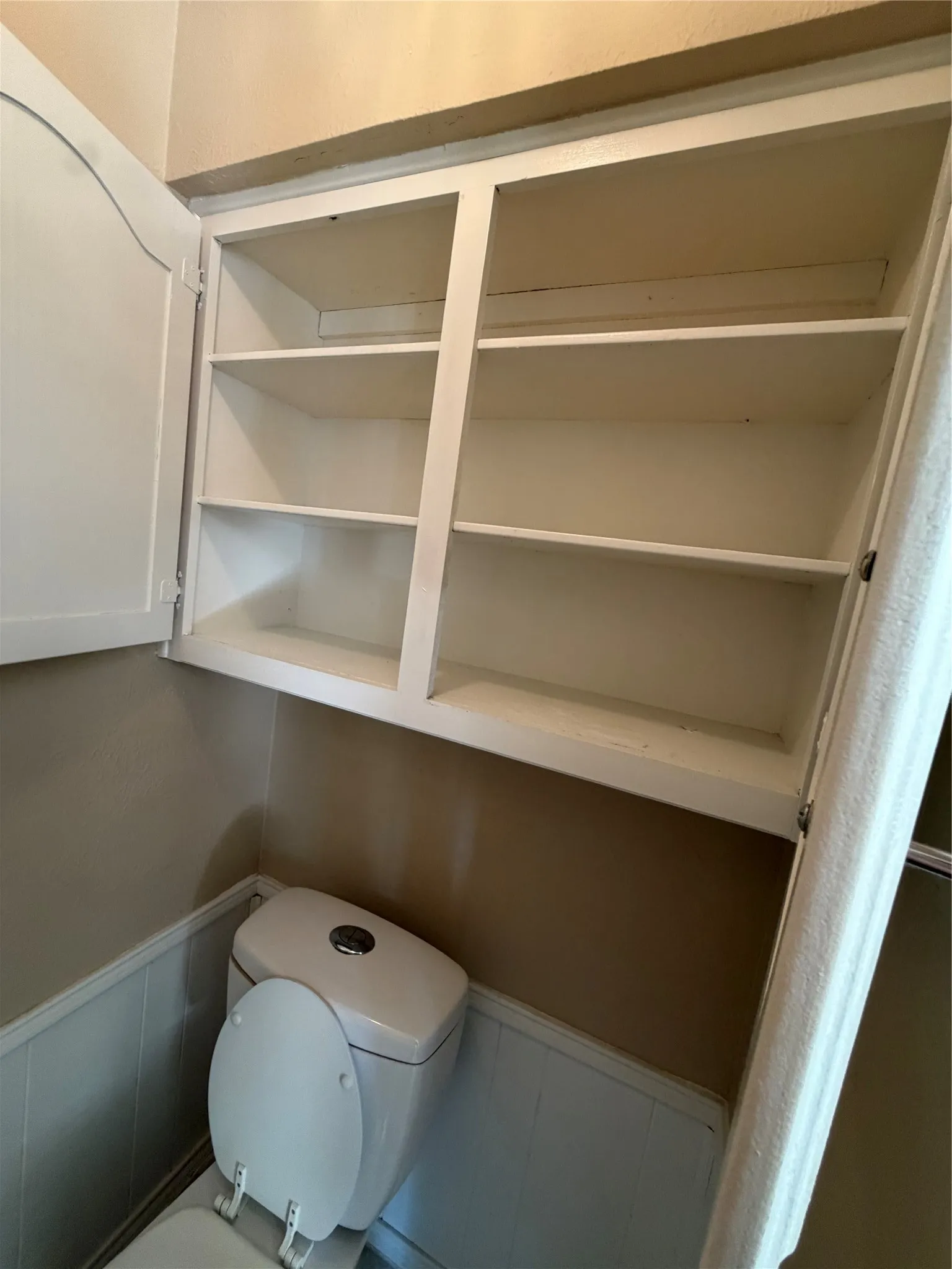 Built-in white cabinetry with multiple shelves