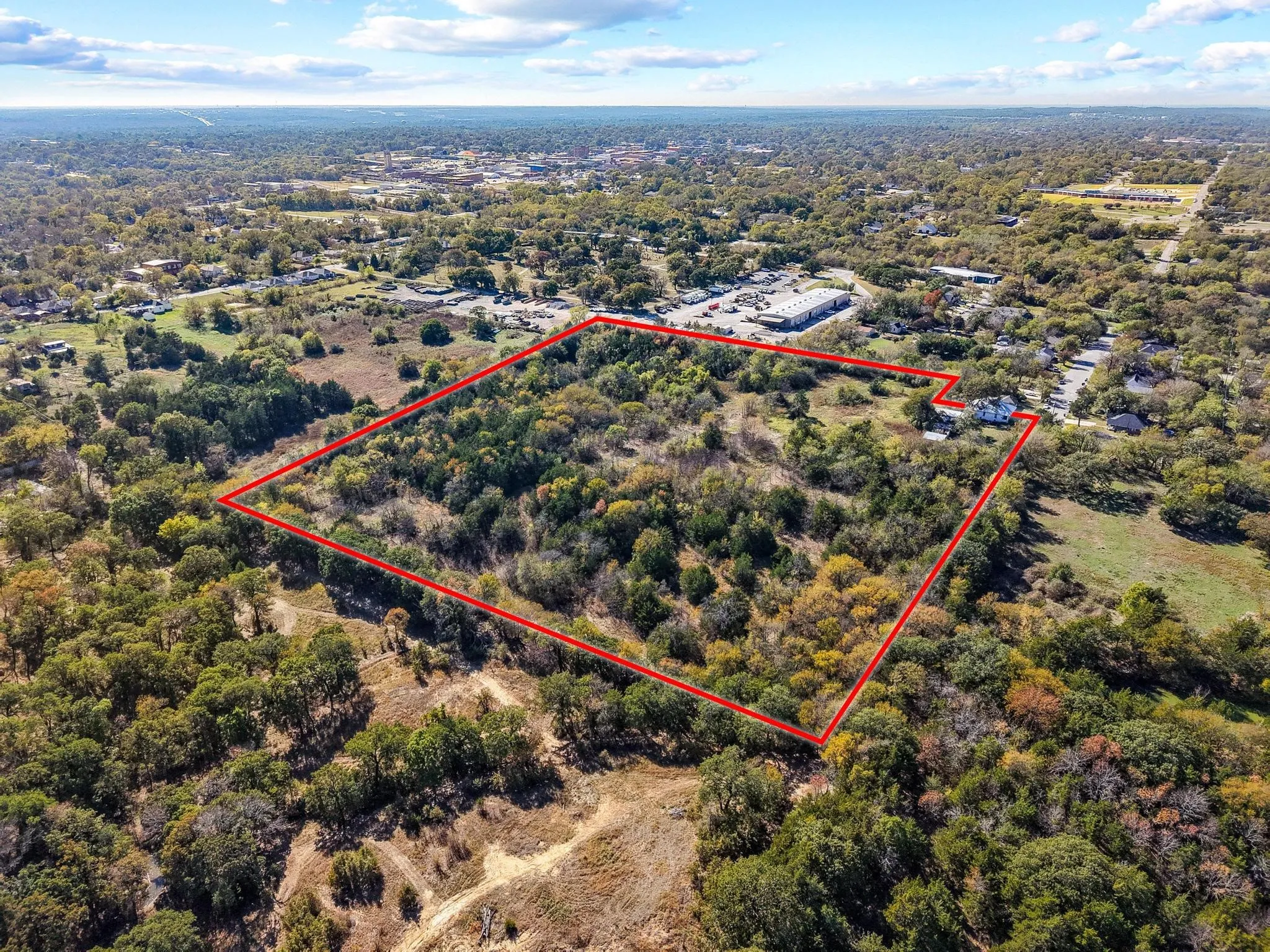 Expansive land parcel with significant tree coverage