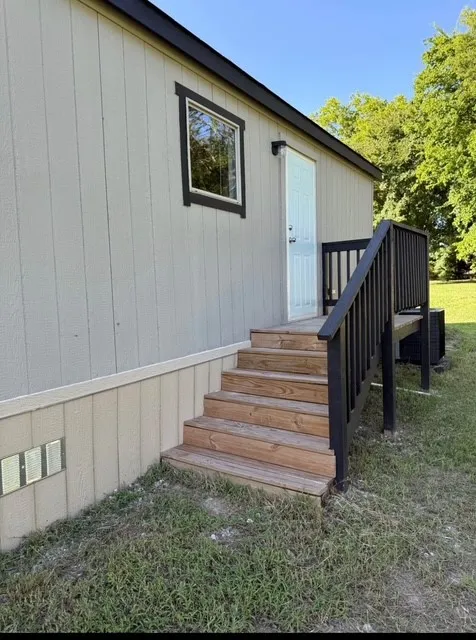 Property entrance with a yard
