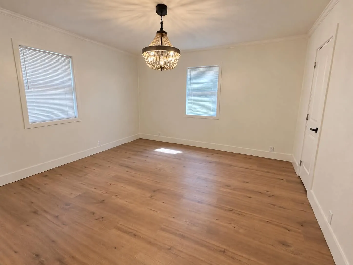 Primary bedroom featuring a "fandelier". Yep, that's a fan!