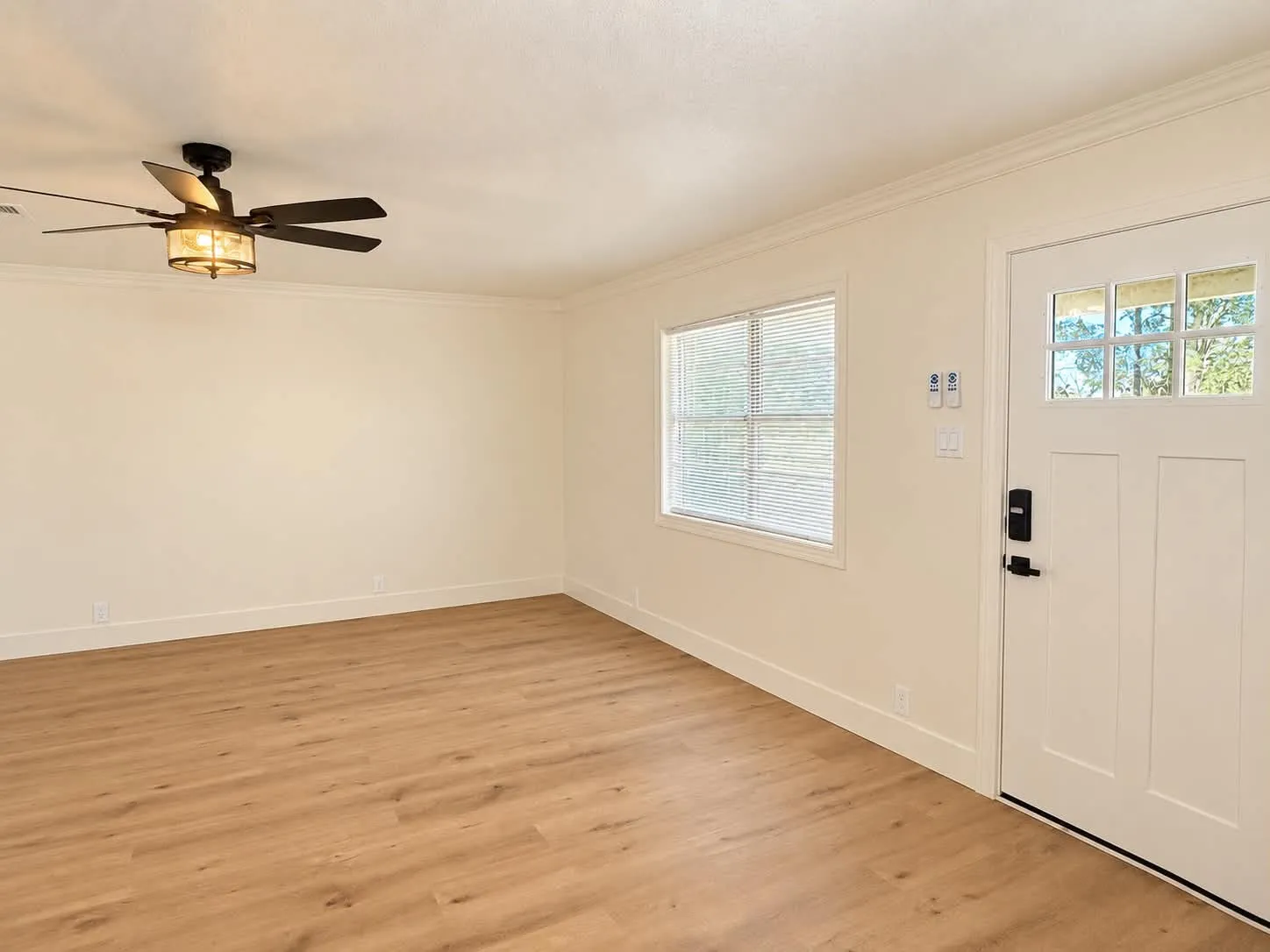 Entryway with brand new exterior door and blinds.