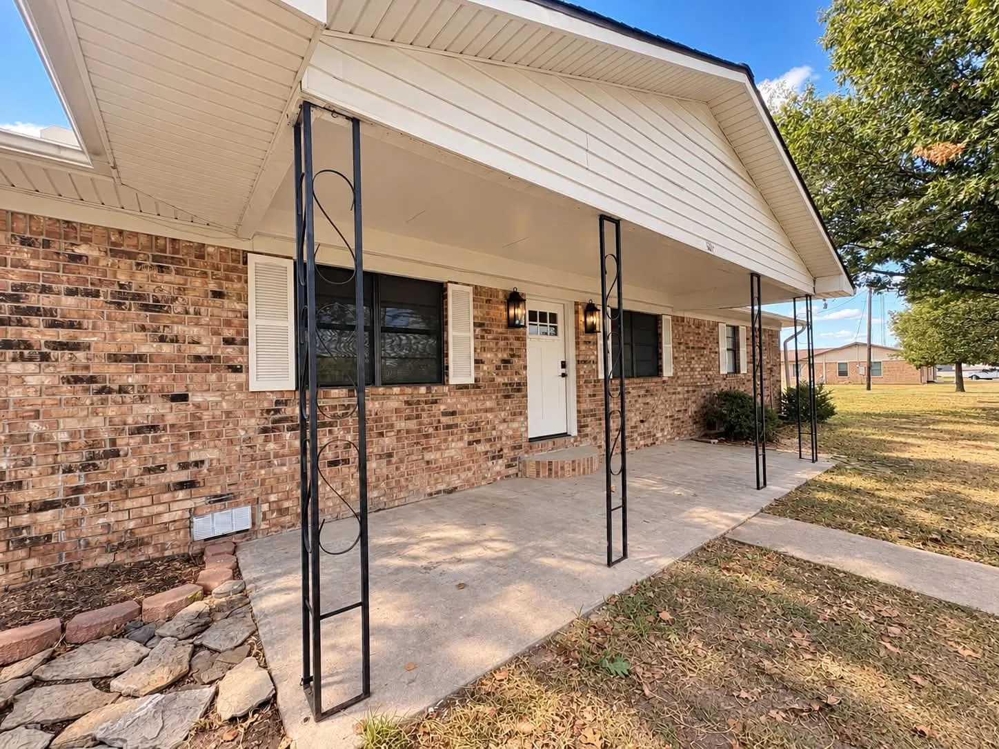 Brick exterior with fresh paint accents.