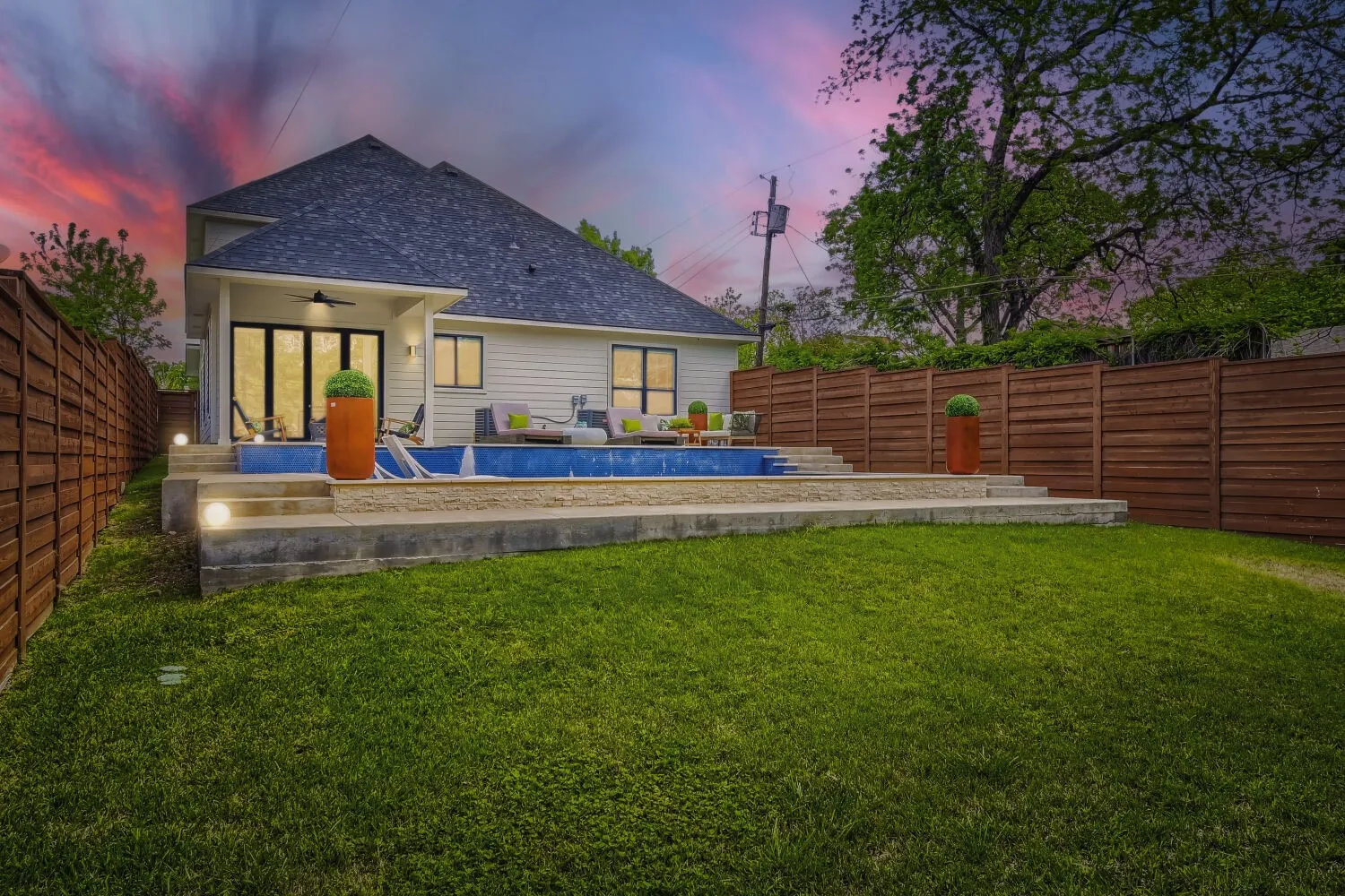Rear view of property featuring ceiling fan, a patio, a fenced backyard, and roof with shingles