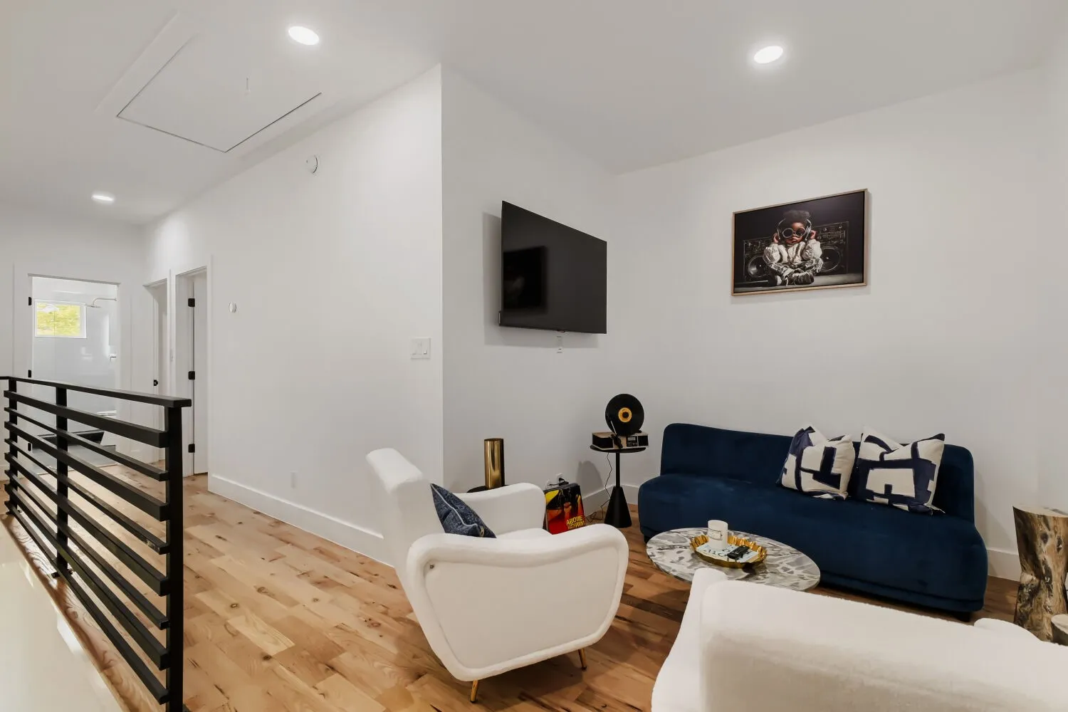 Living area with wood finished floors and recessed lighting