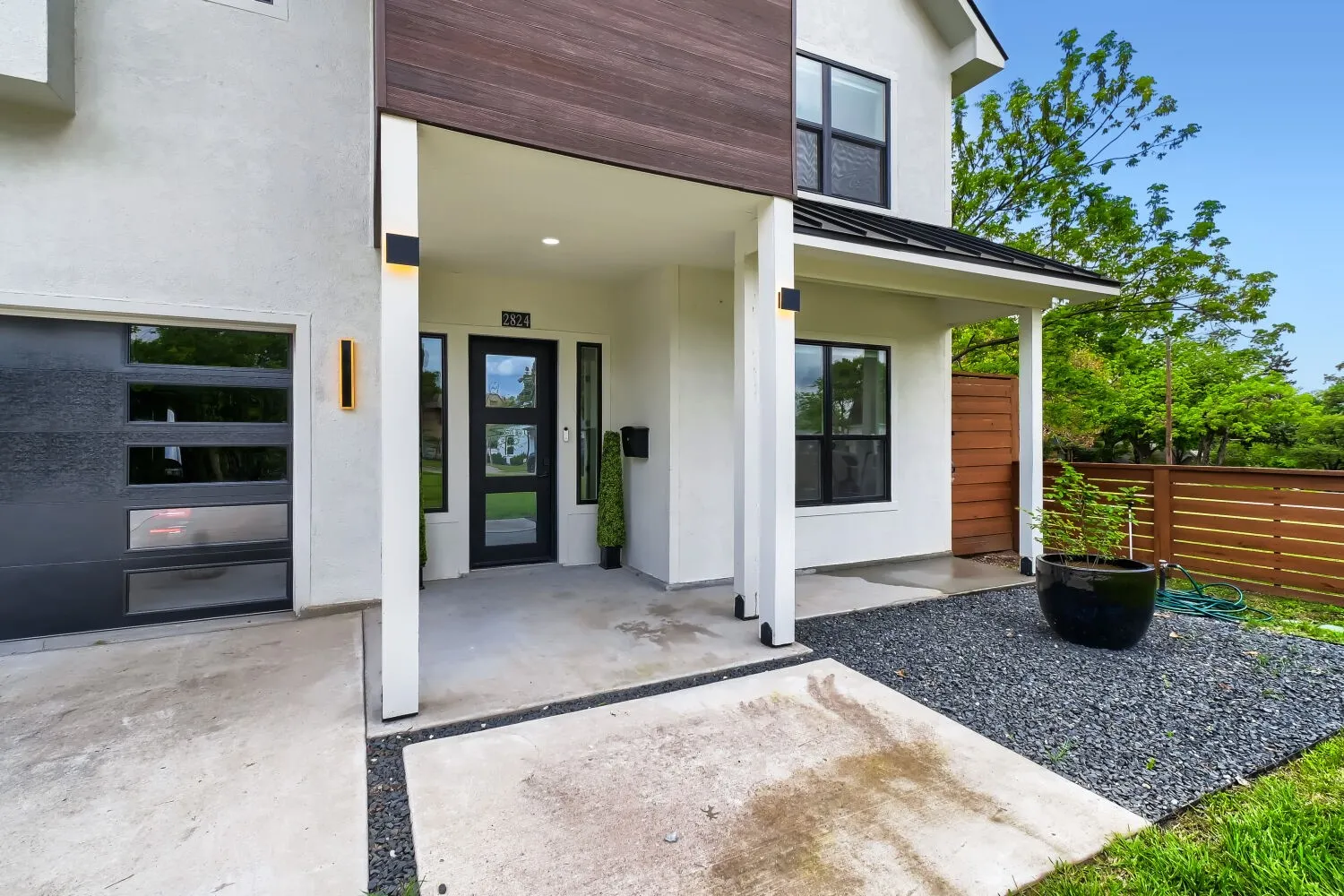 Property entrance featuring a standing seam roof, stucco siding, and covered porch
