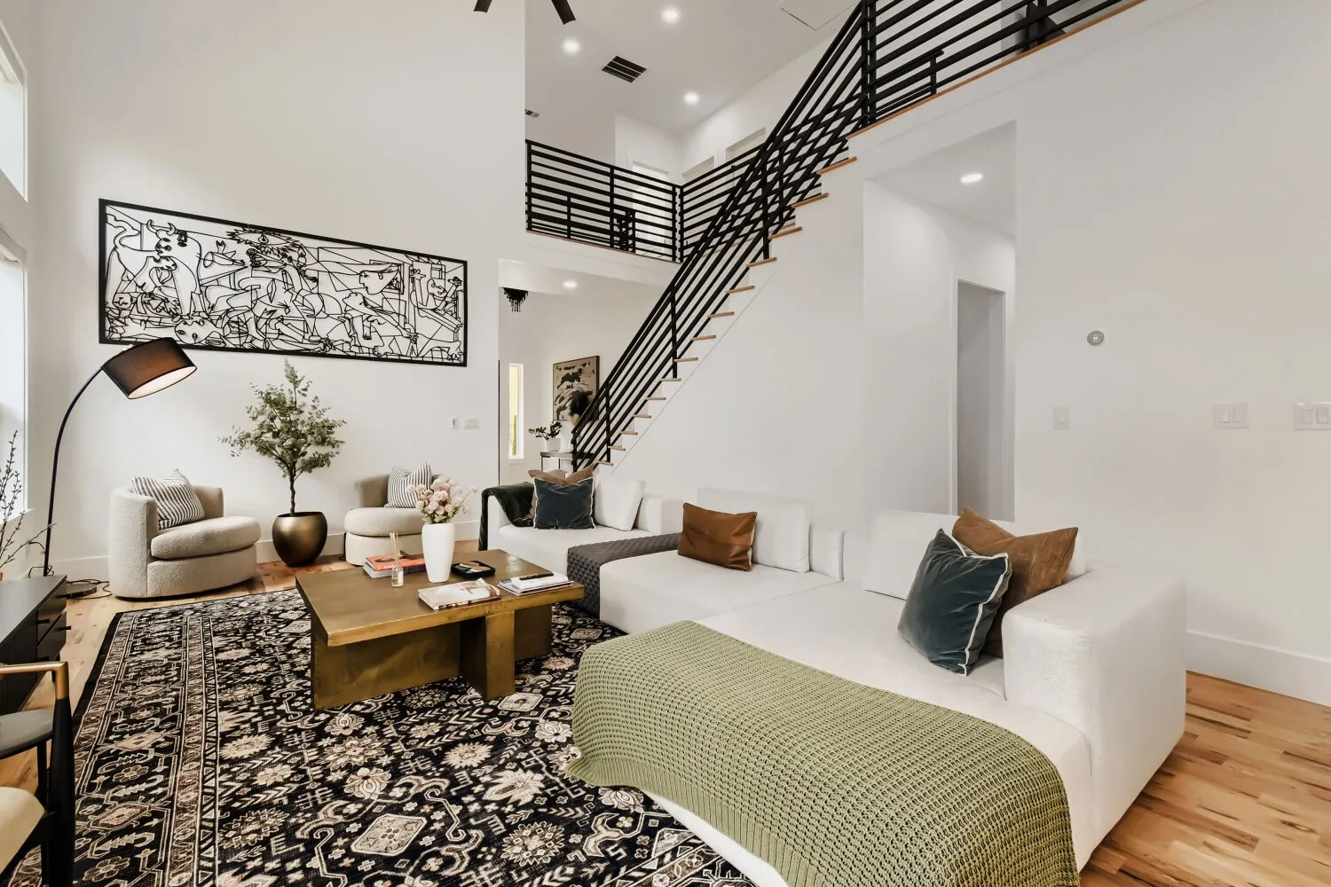 Living room with wood finished floors and a high ceiling