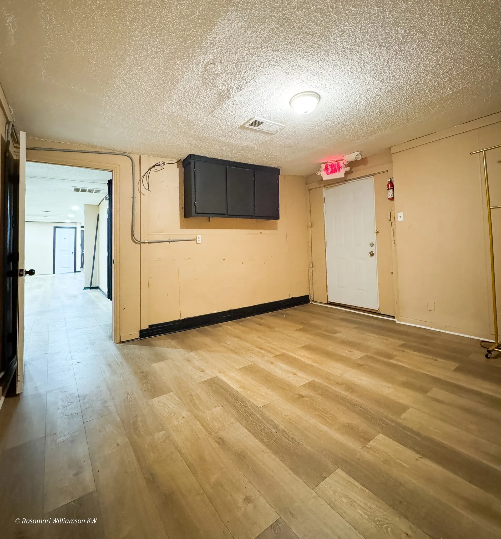 Room at the back of the building with rear entry leading to parking. Could be breakroom or reception waiting area.