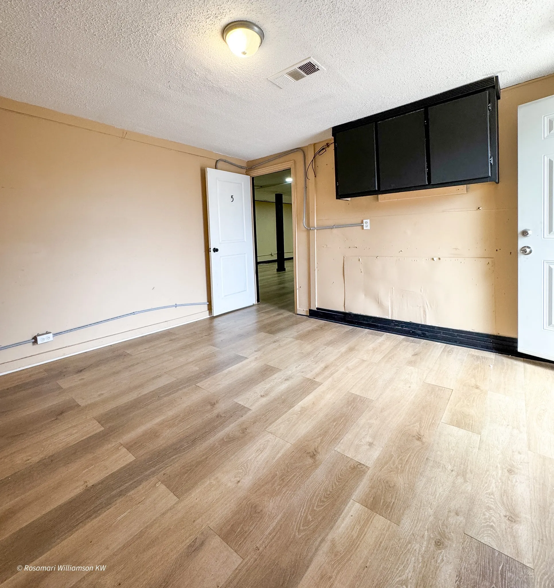 Room at the back of the building with rear entry that leads to parking. Could be breakroom or reception waiting area.