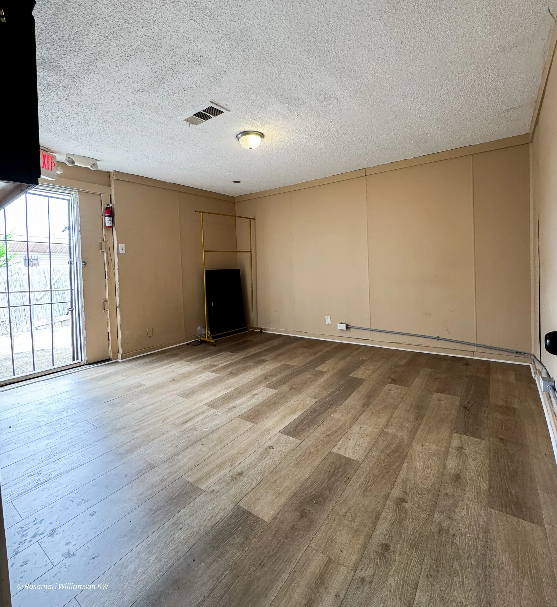Room at the back of the building with rear entry that leads to parking. Could be breakroom or reception waiting area.