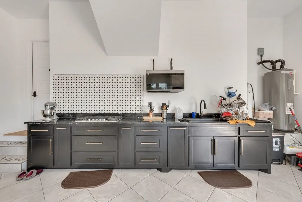 Full kitchen in the garage with propane tank and gas stove