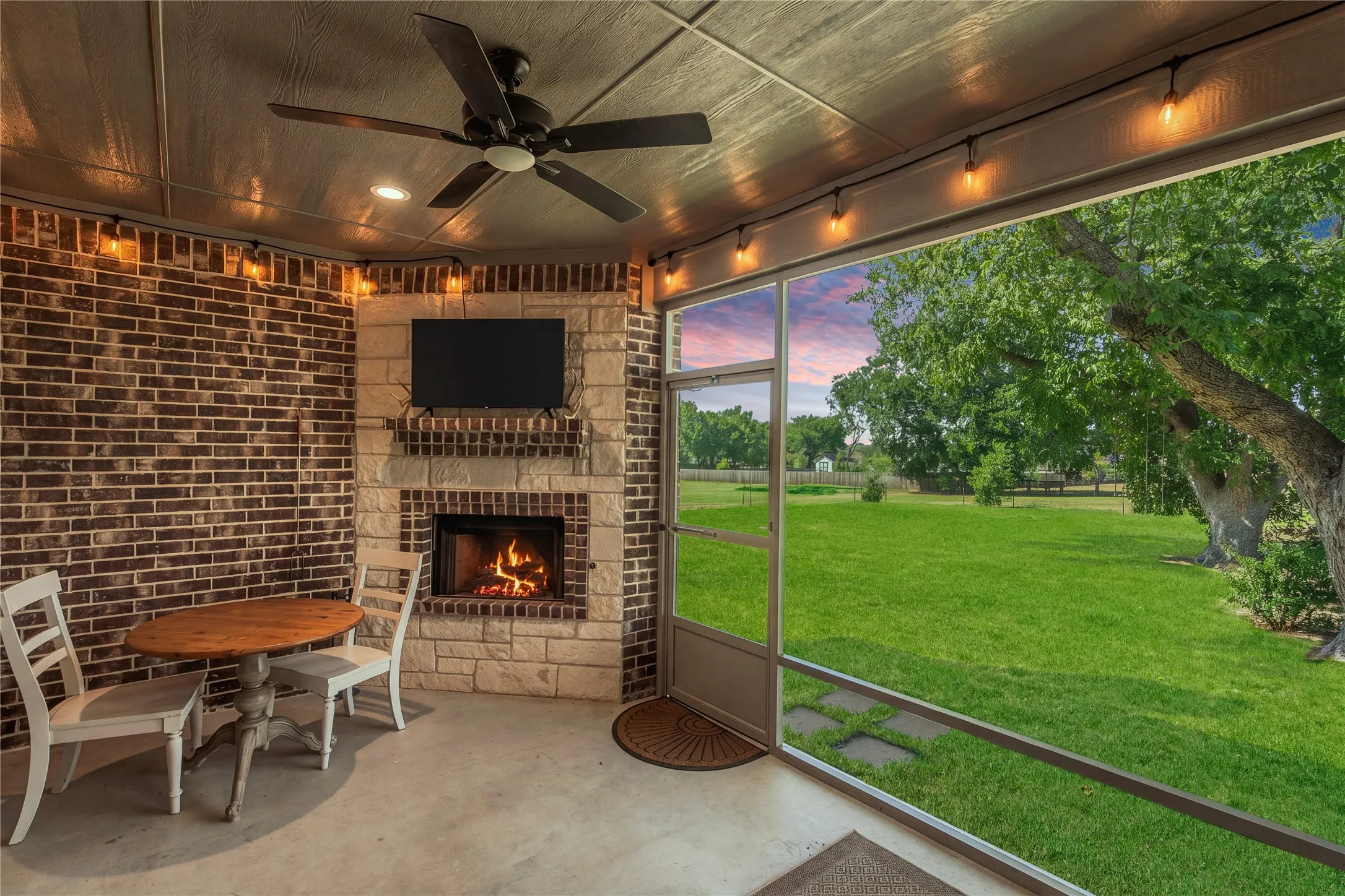 Screened-in patio for an outdoor living room, creates a comfortable place to gather while staying protected from the elements. A second gas fireplace for cozy moments in those cooler seasons.