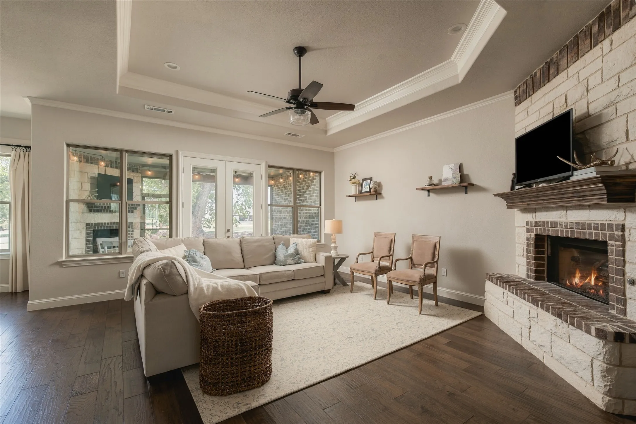 The main living room combines generous proportions, hardwood flooring and a fireplace focal point while remaining open to the kitchen.