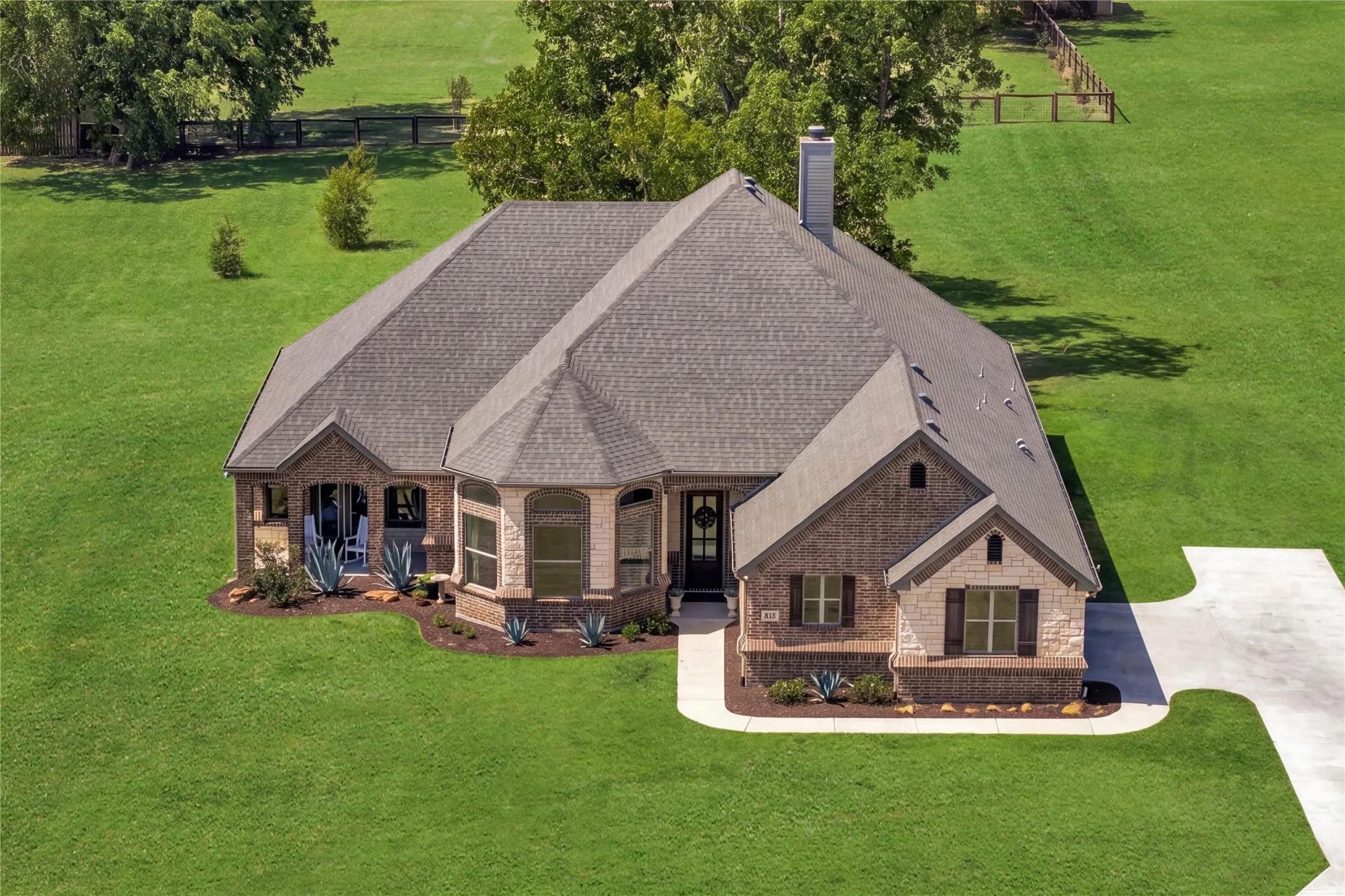One acre of breathing room beneath mature trees, pairing newer construction with a setting increasingly difficult to find.