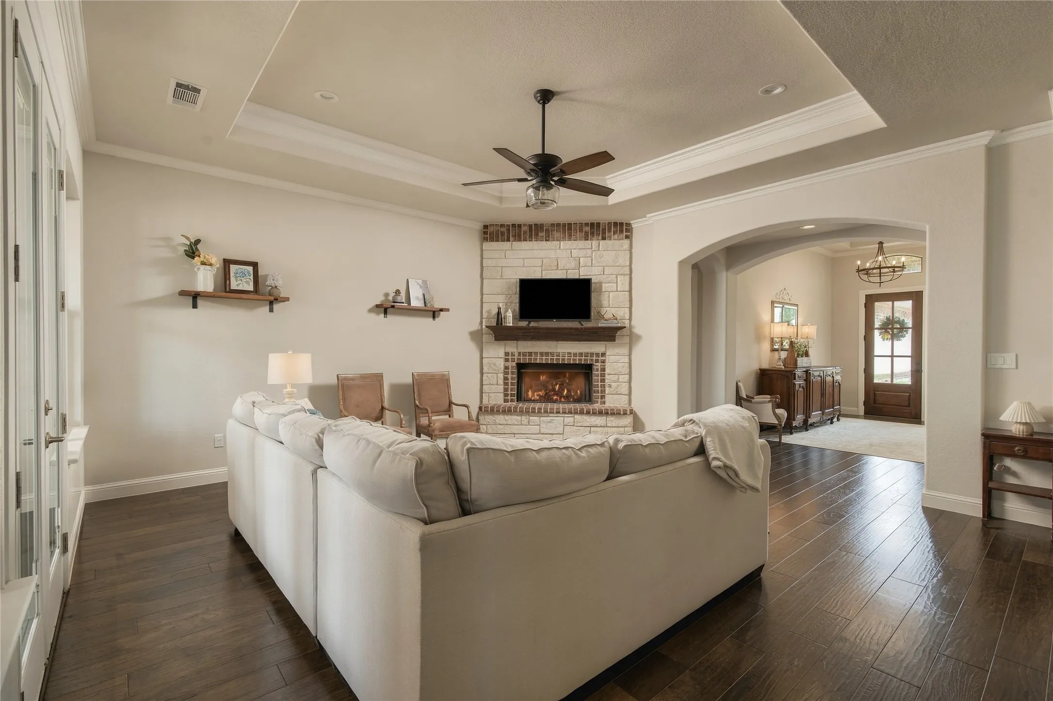 Coffered ceiling detail and extensive natural light give the living room architectural presence while maintaining a relaxed, livable scale.