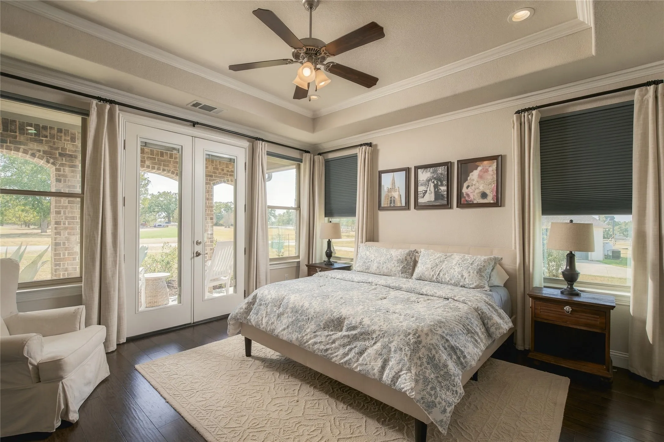 The spacious owner's suite offers tray ceilings, hardwood floors and abundant natural light for a quiet retreat from the main living areas.