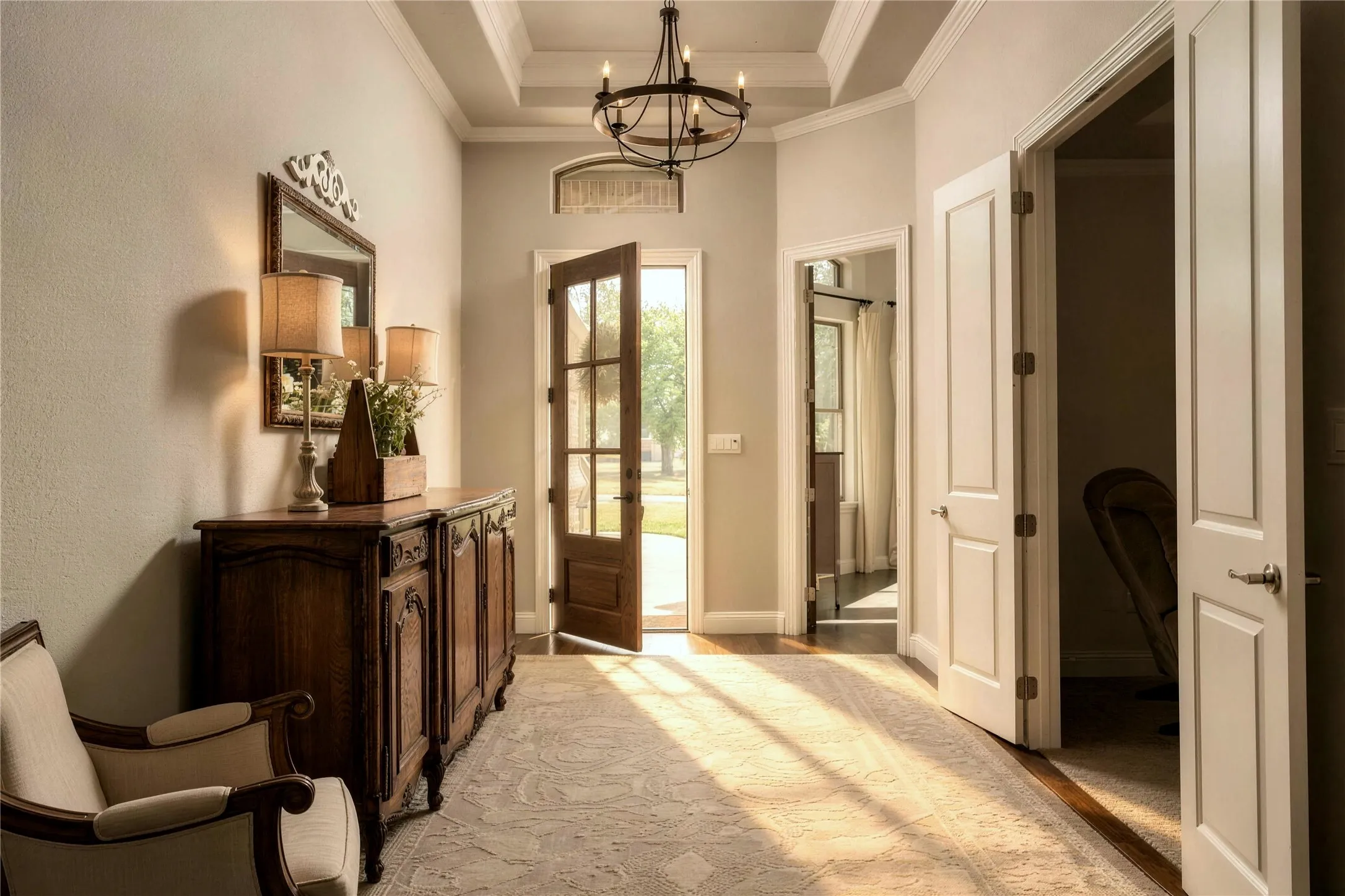 A welcoming entry framed by hardwood floors, crown molding and elevated ceiling detail sets the tone from the moment you arrive.