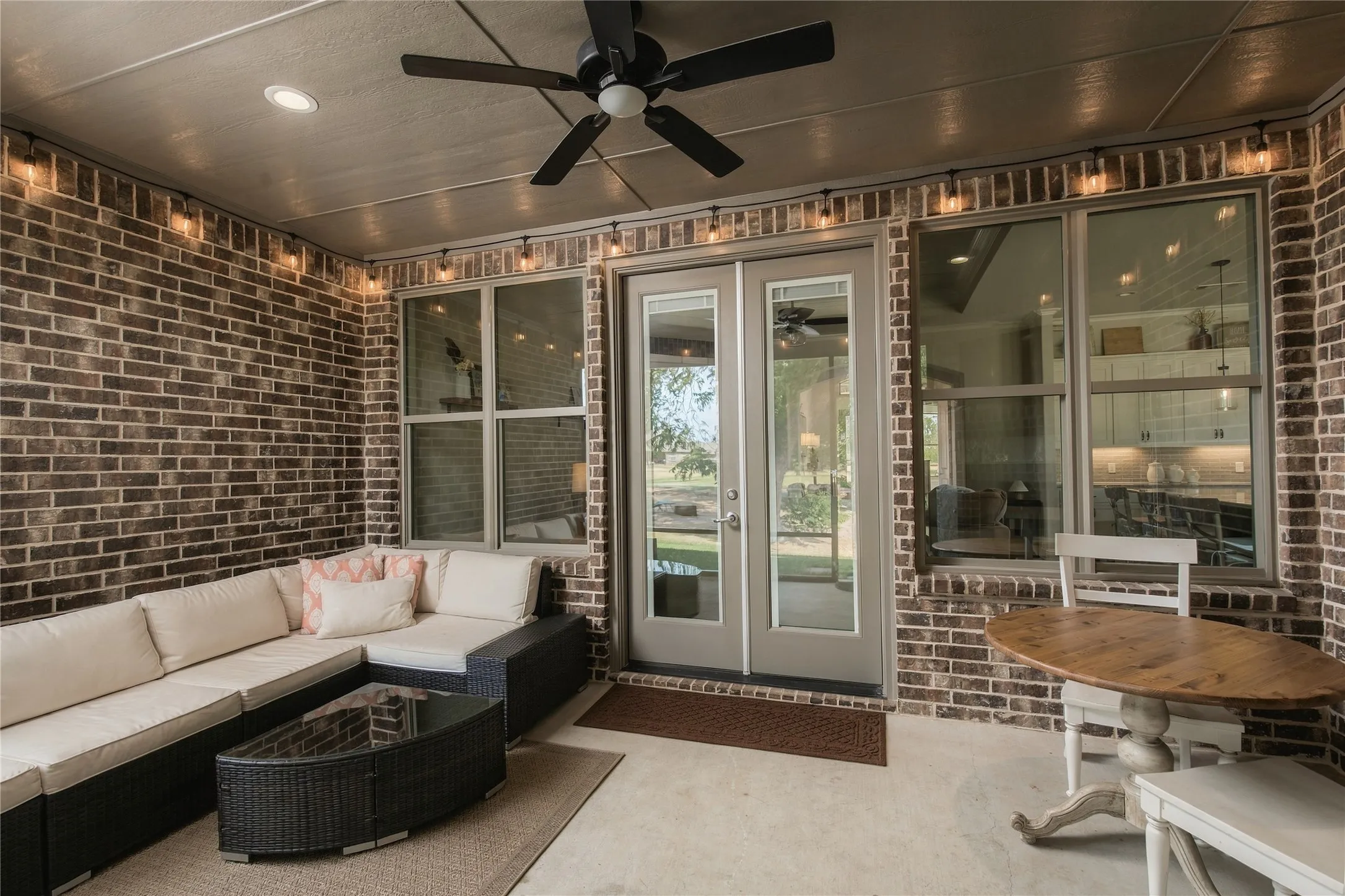 The covered and screened outdoor living area feels integrated into the home rather than added on, extending usable living space toward the backyard.