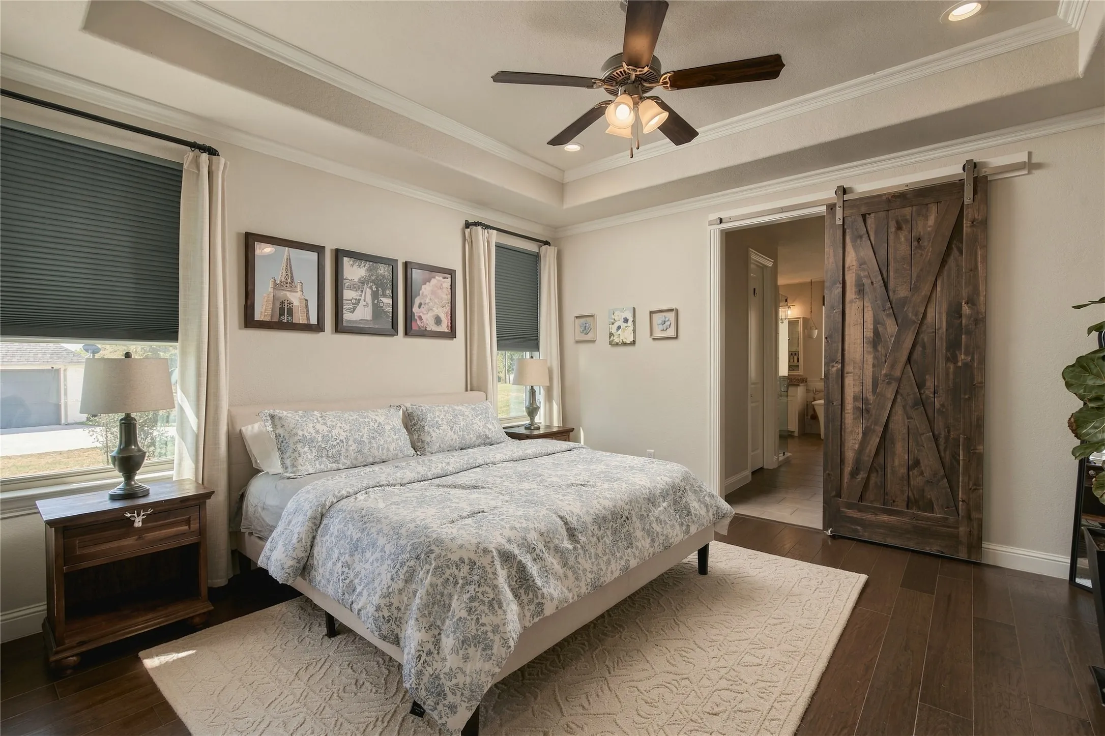 Tray ceiling with recessed lighting, wood-finish flooring, and a ceiling fan