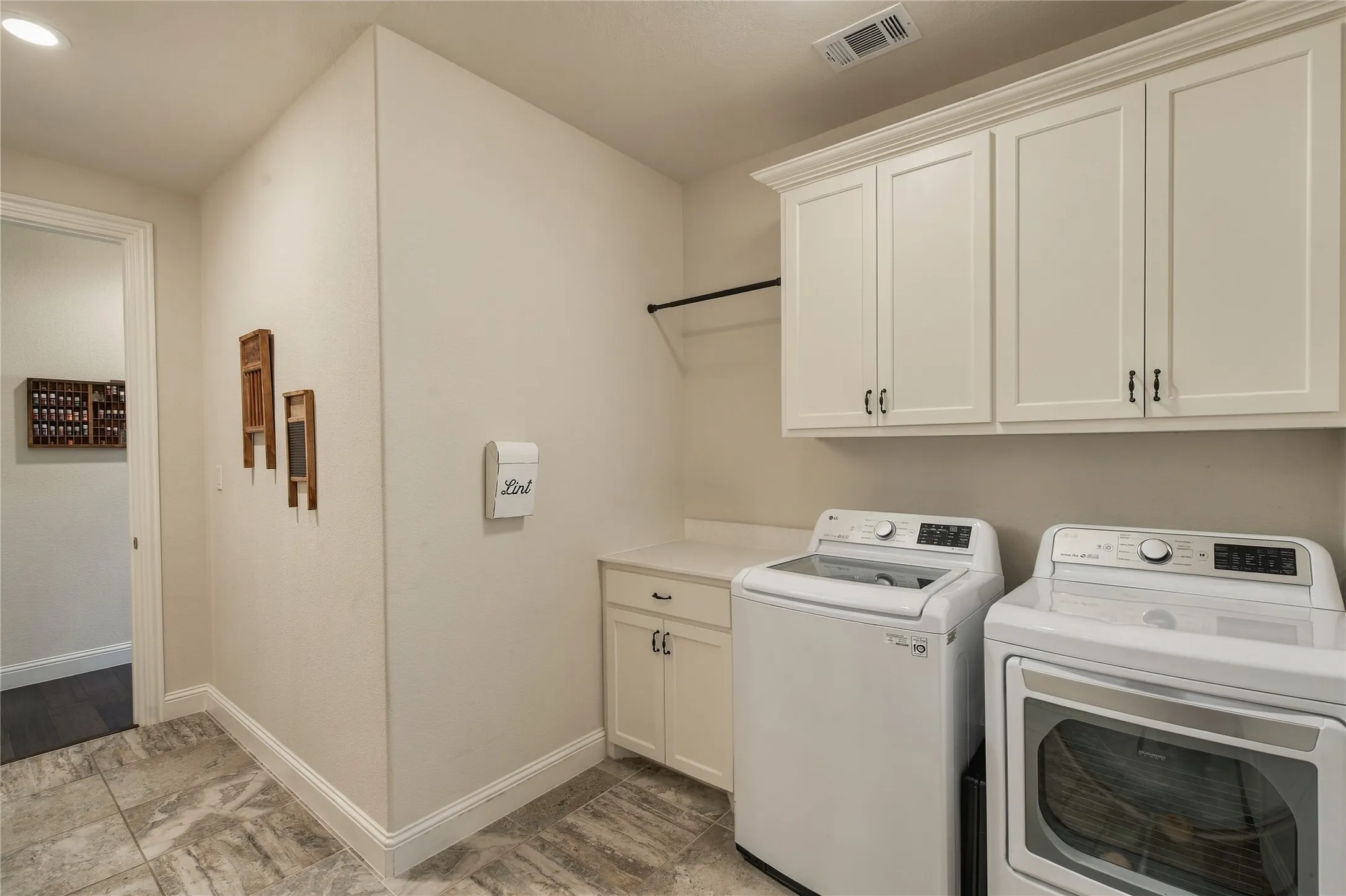 A true utility space with built-in cabinetry adds the storage and functionality needed to keep everyday household tasks organized.