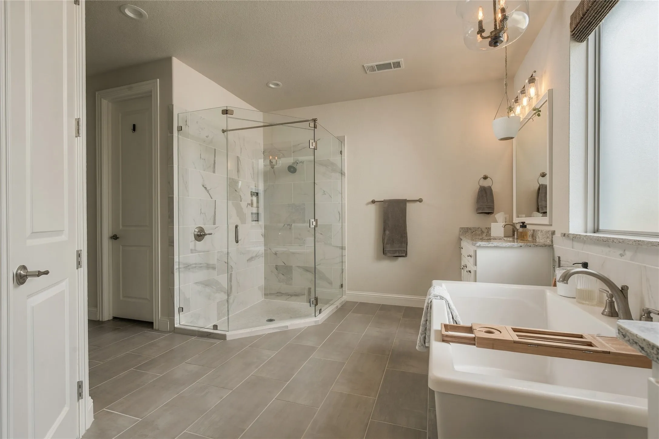 The oversized primary bath offers separate zones for bathing, showering and daily routines, giving two people room to comfortably share the space.