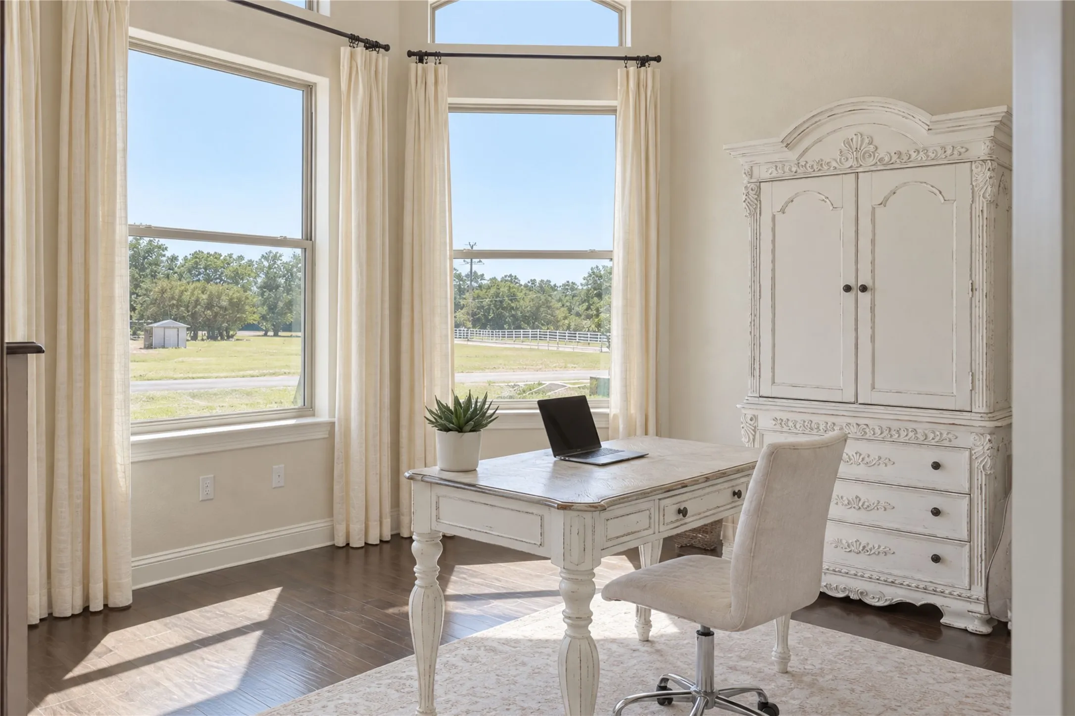 A dedicated home office with natural light and peaceful views provides separation for focused work without sacrificing connection to the home.