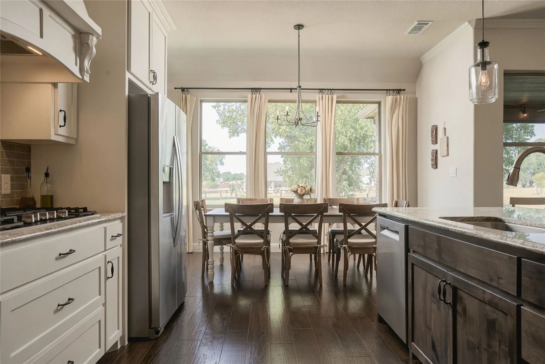 Open sightlines between the kitchen and dining area keep everyday meals and larger gatherings naturally connected.