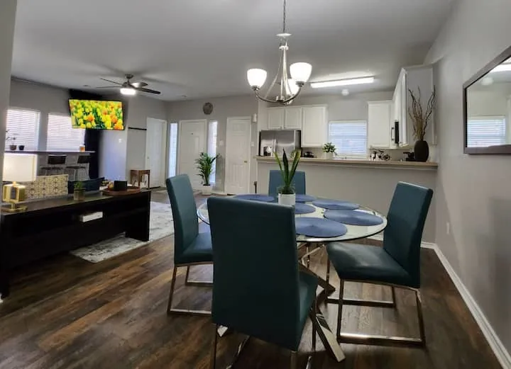 Open-concept living area with wood-finish flooring, a contemporary ceiling fan, and recessed lighting