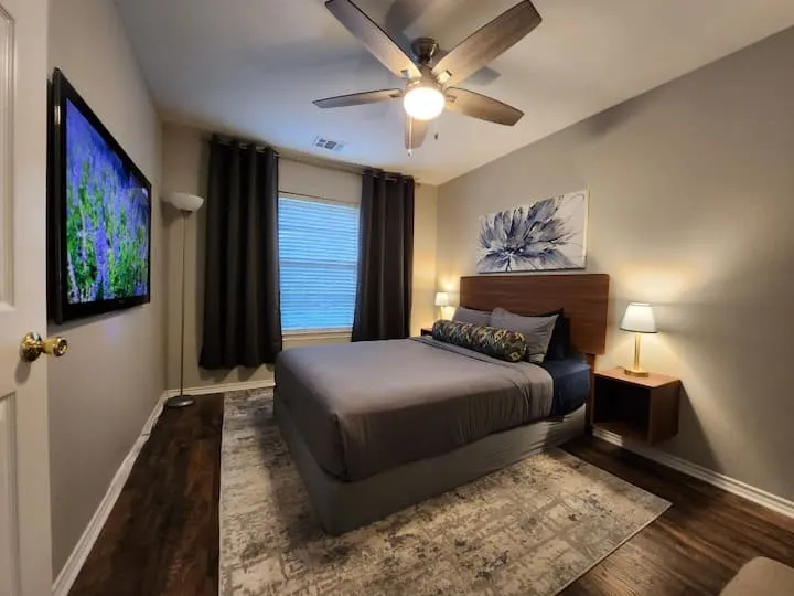 Wood-finish flooring with neutral wall tones and a ceiling fan