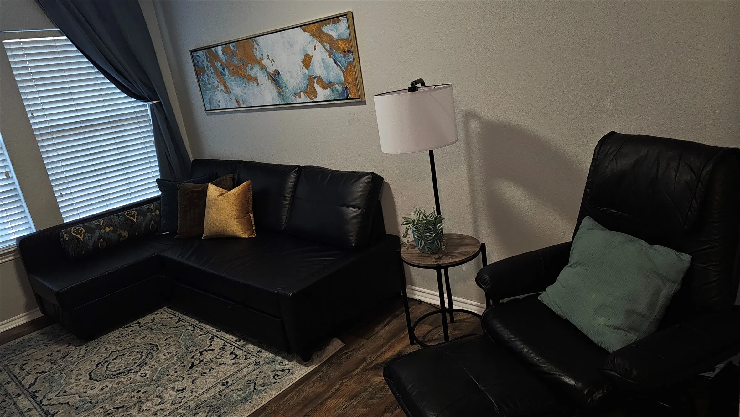 Wood-finish flooring with neutral wall paint and window blinds