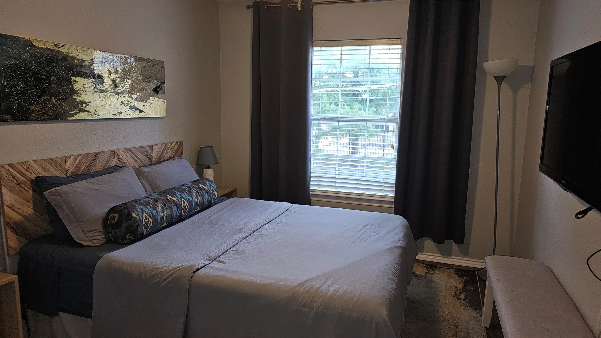 Window with horizontal blinds and full-length  drapes