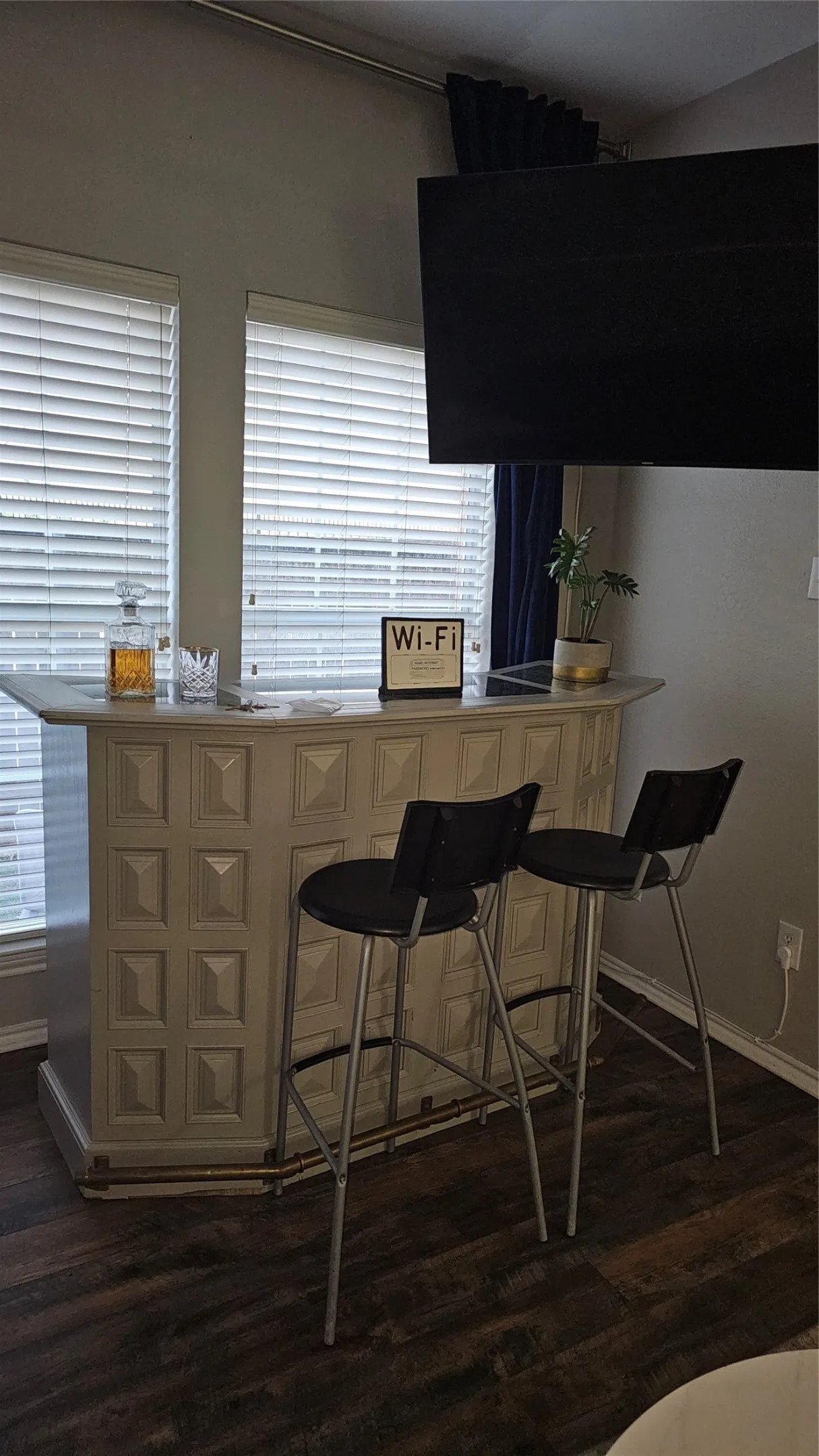Wood-finish flooring with a built-in bar, featuring a light-toned countertop