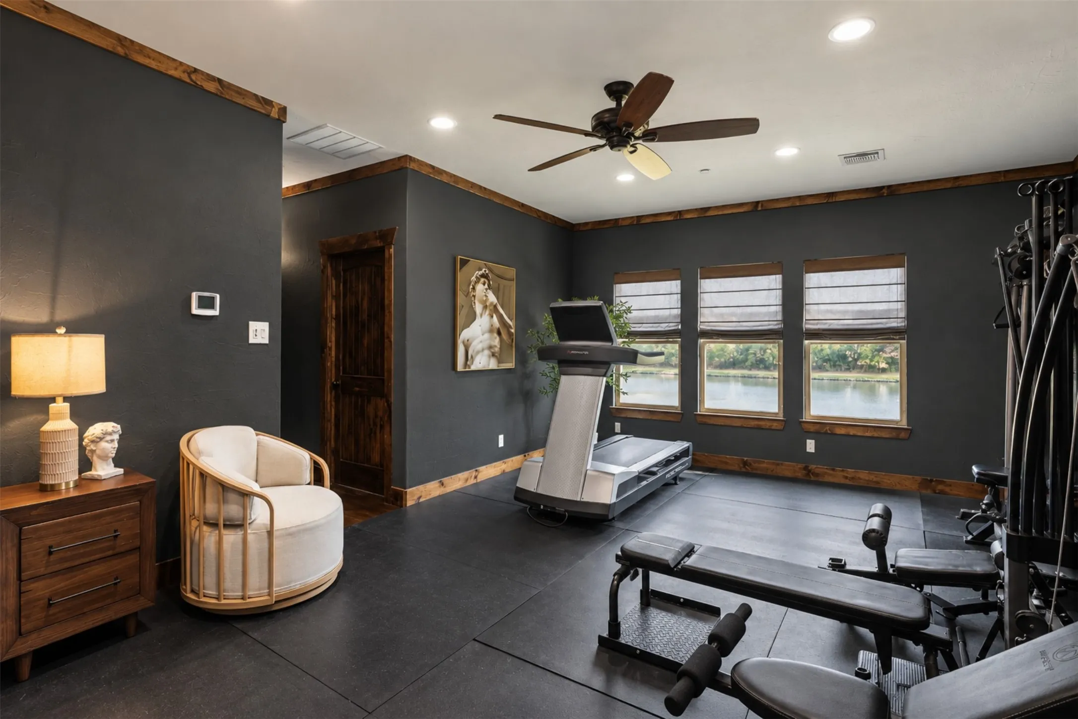 Recessed lighting, ceiling fan, wood-finish trim throughout, dark-toned walls, and multiple windows
