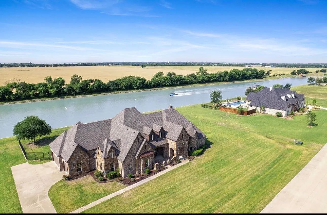 Stone veneer exterior with multiple gables and a dark shingle roof
