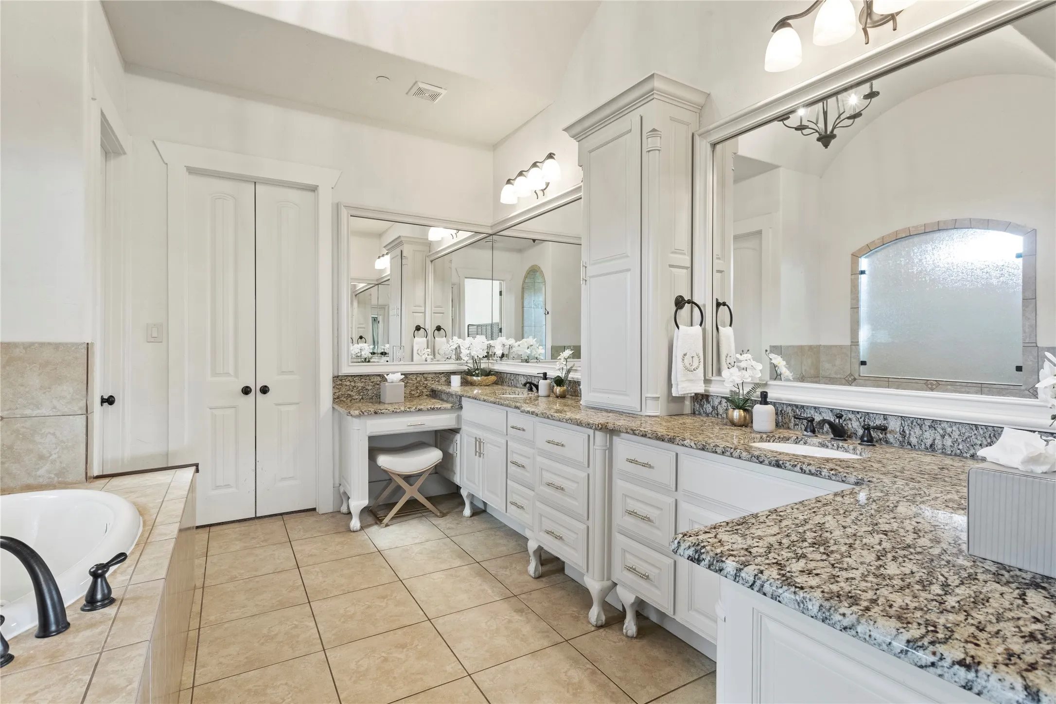 Dual vanities with granite countertops and undermount sinks