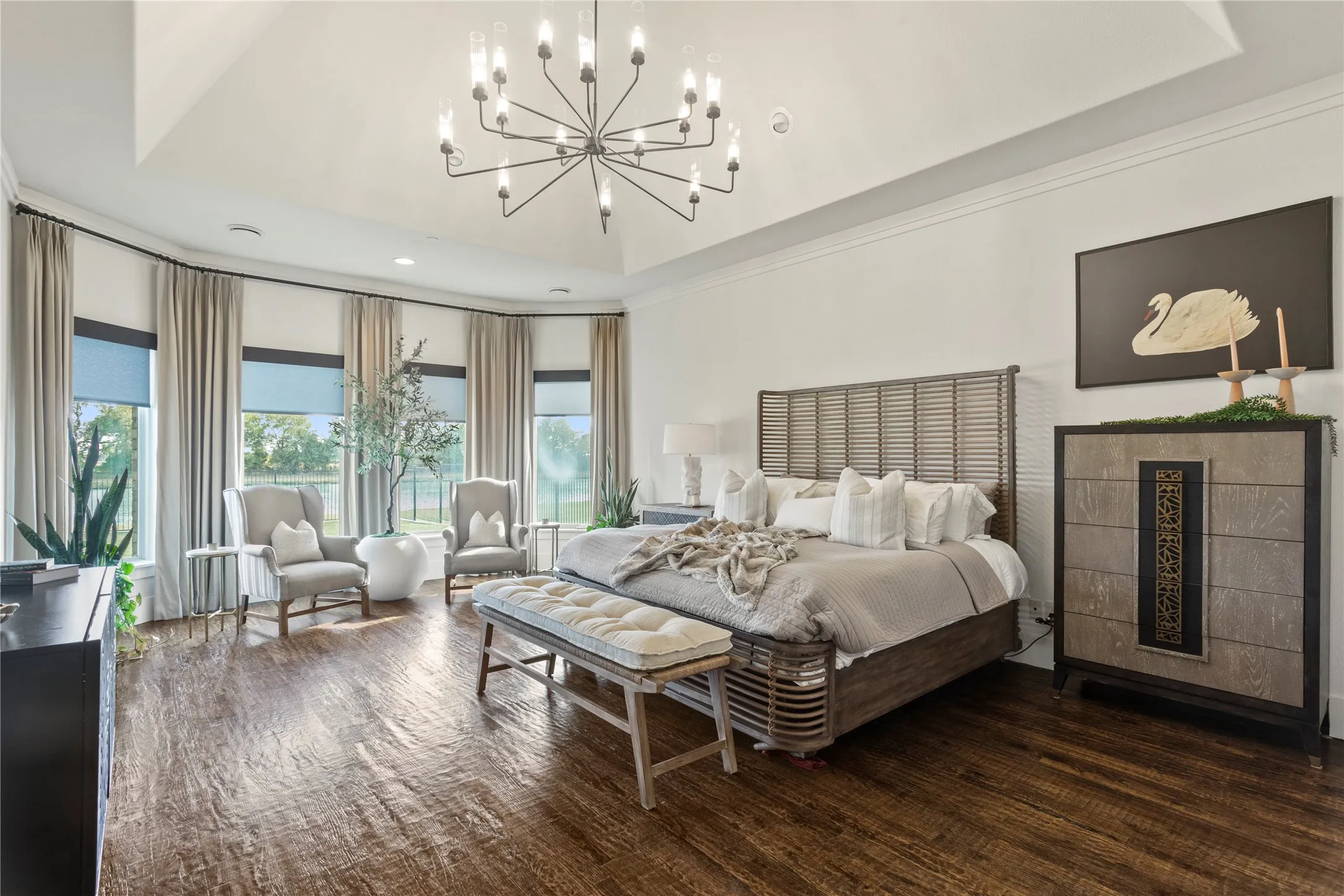 Tray ceiling, dark wood-finish flooring, bay window with multiple panes, contemporary chandelier, and recessed lighting