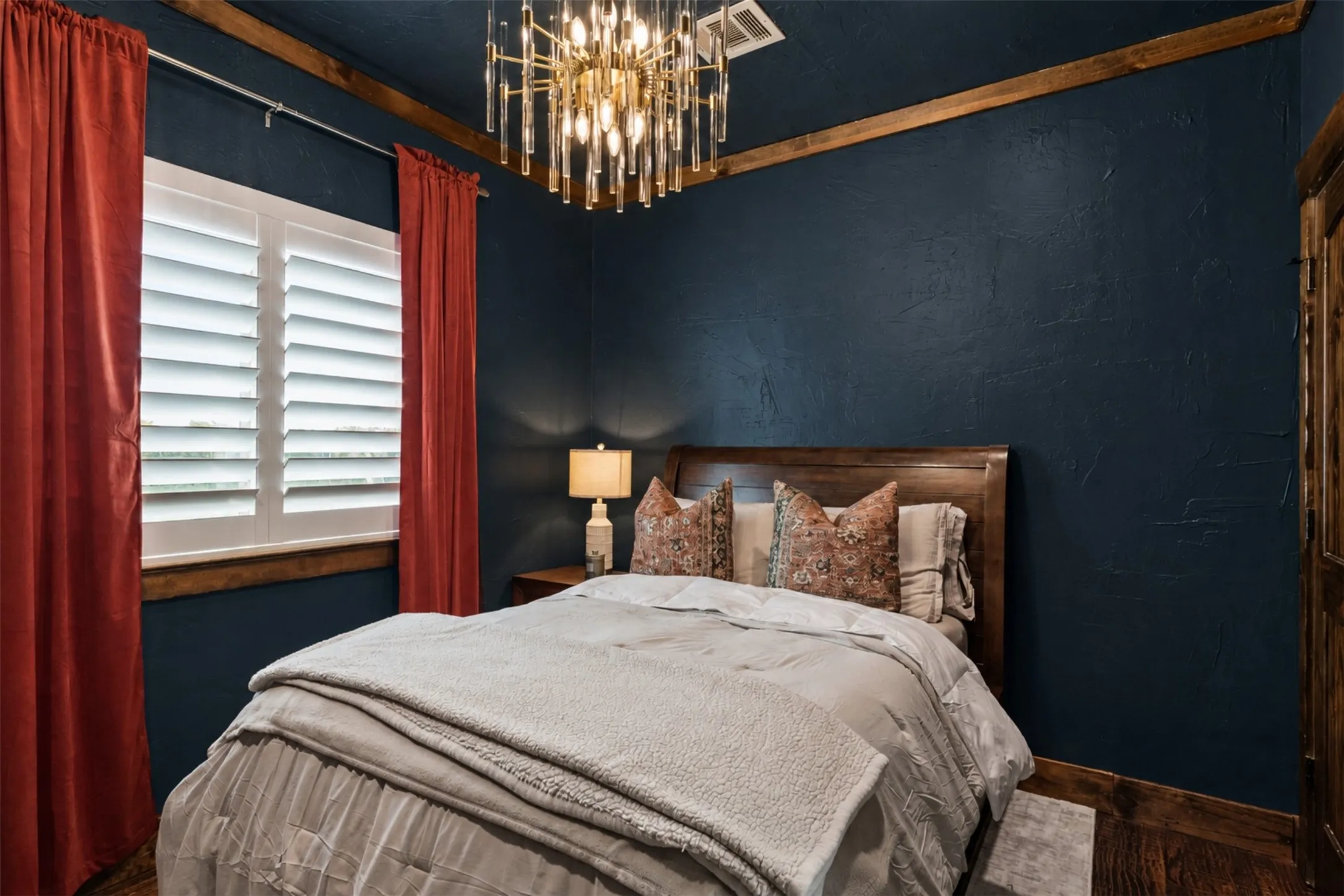 Wood-finish flooring, plantation shutters, and a distinctive wood-beamed ceiling