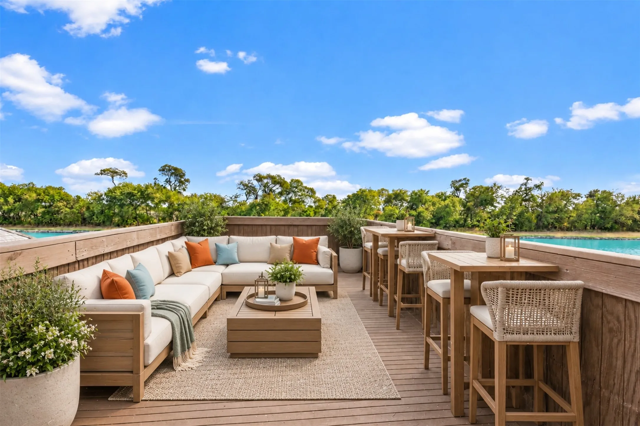 AI Staged Expansive outdoor deck featuring wood-look flooring, built-in perimeter wall, and water backdrop