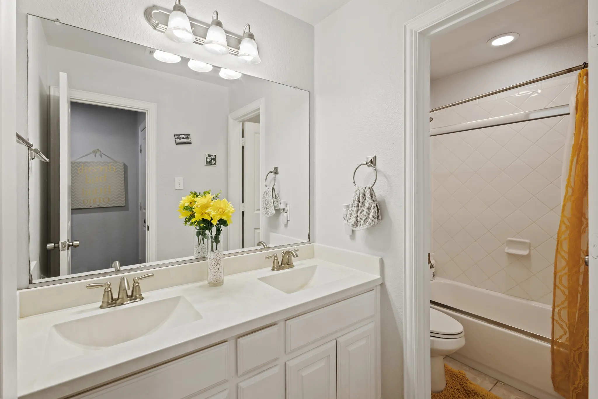 Double vanity with integrated sinks and brushed nickel faucets