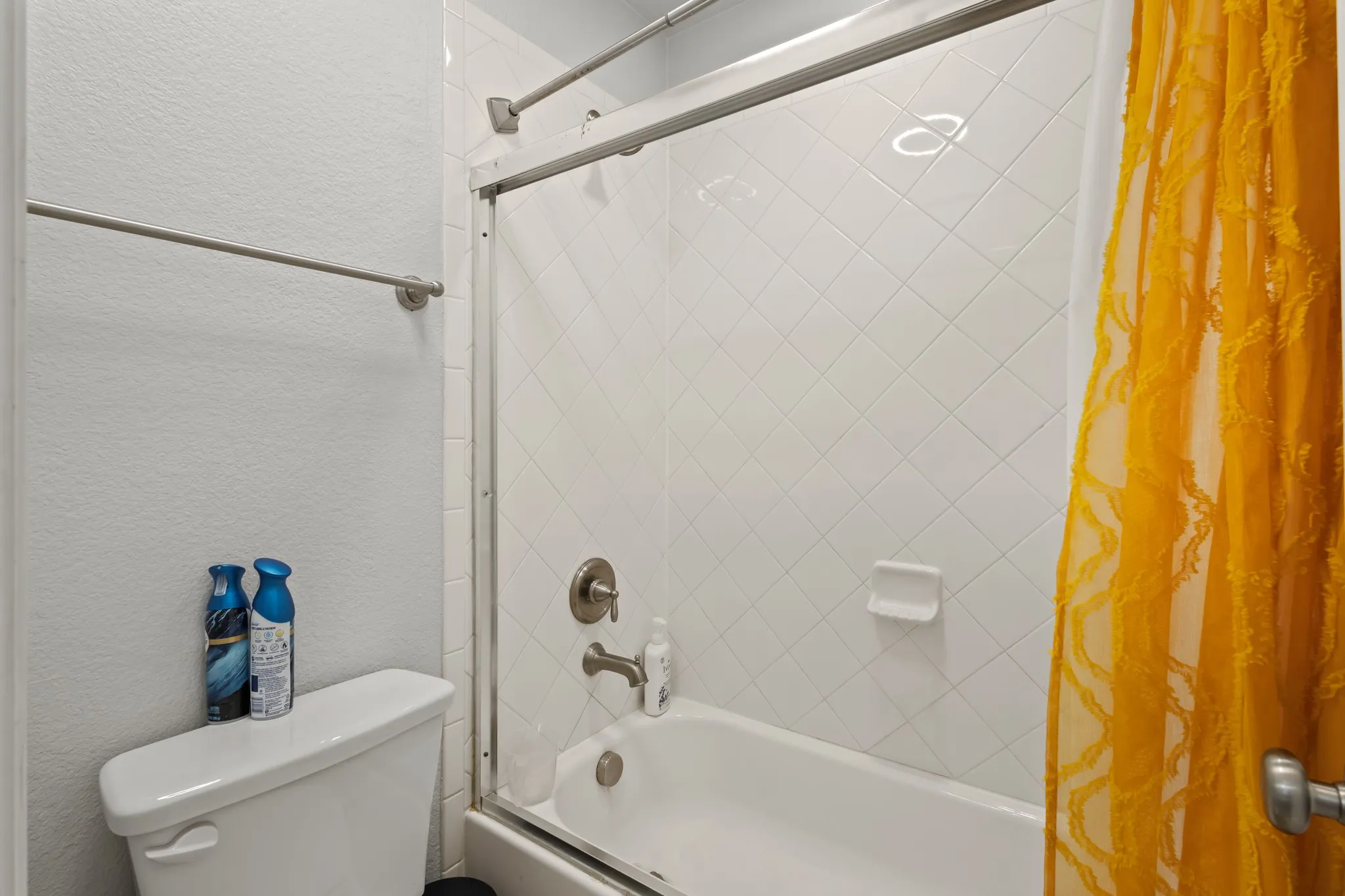 White ceramic tile shower surround with diagonal pattern