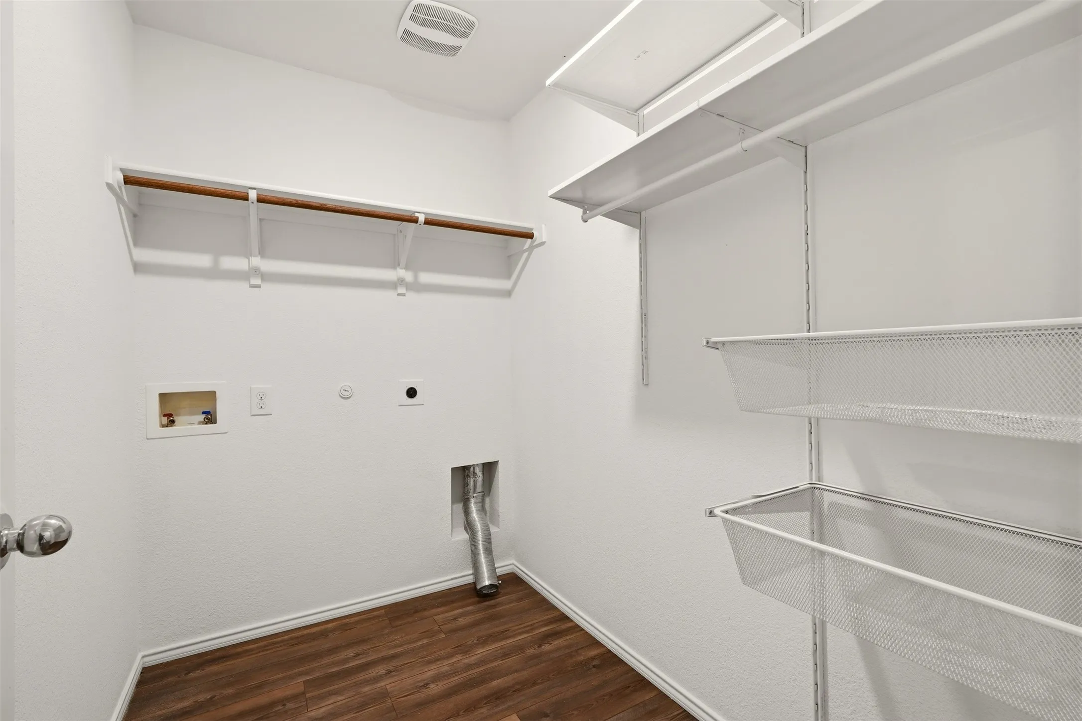 Wood-finish flooring, white walls, built-in shelving, and a wall-mounted clothing rod