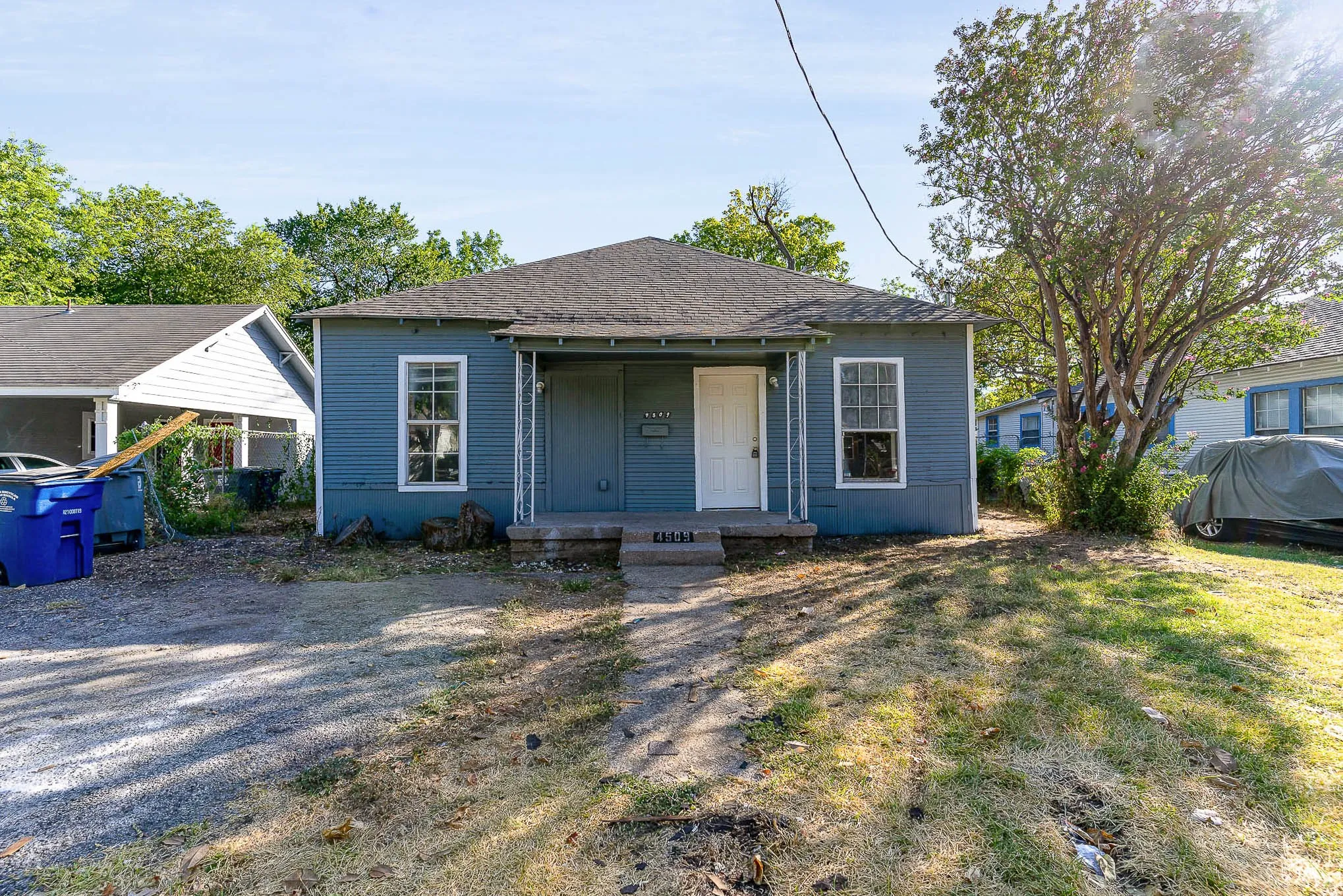 Bungalow with a shingled roof and covered porch