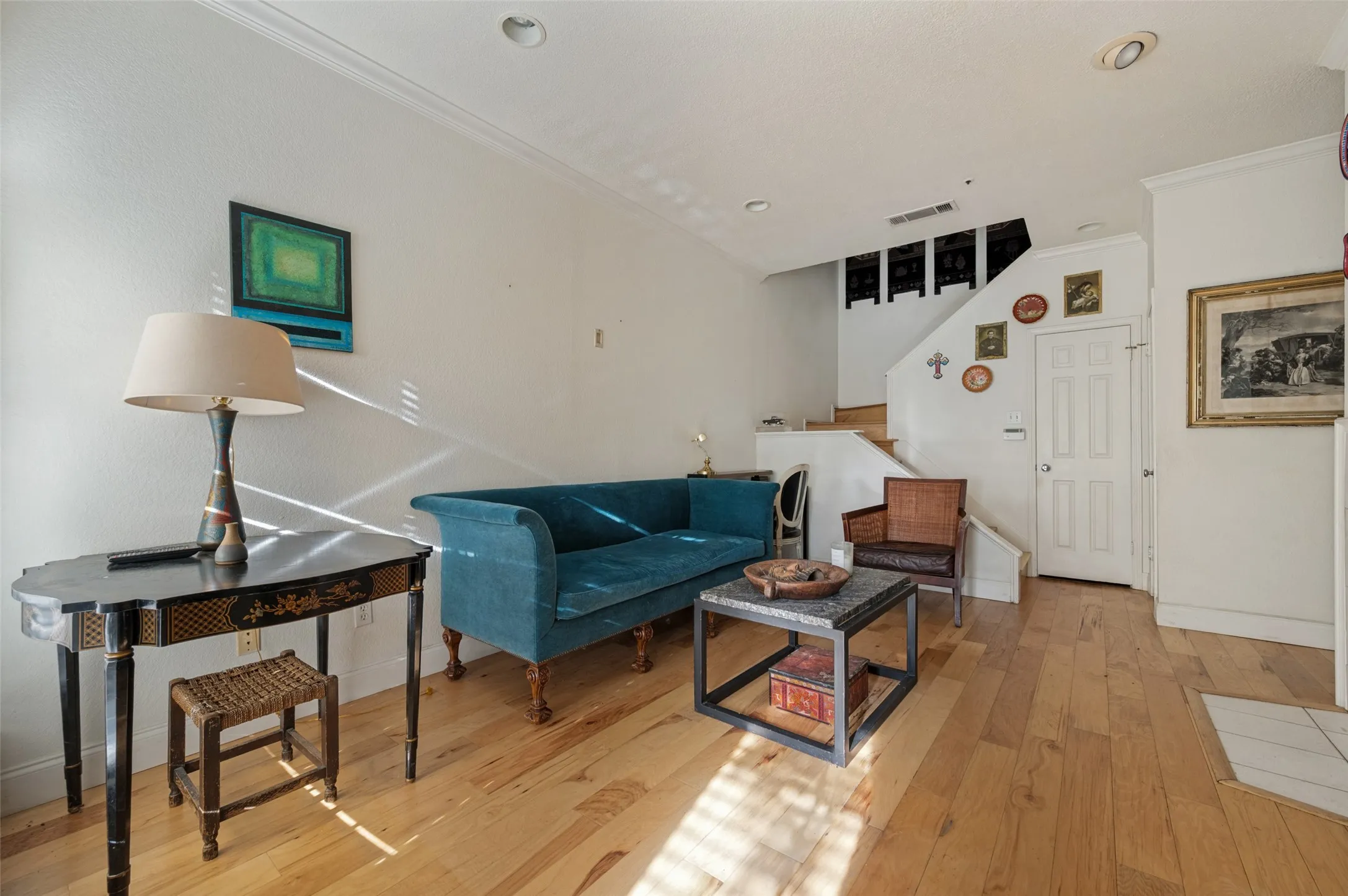 Hardwood flooring, recessed lighting, crown molding, and a paneled interior door