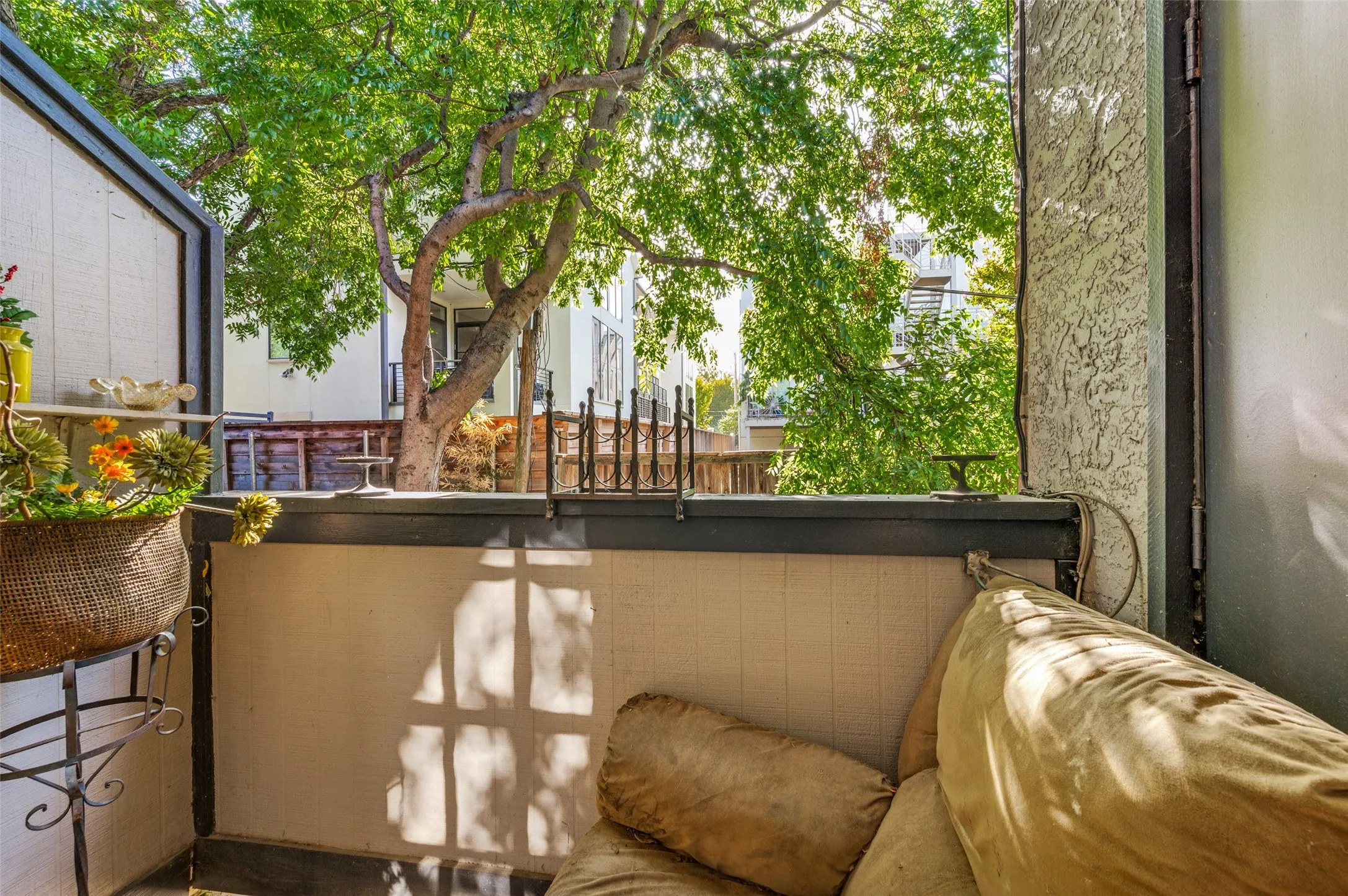 Outdoor balcony with a privacy wall and metal railing