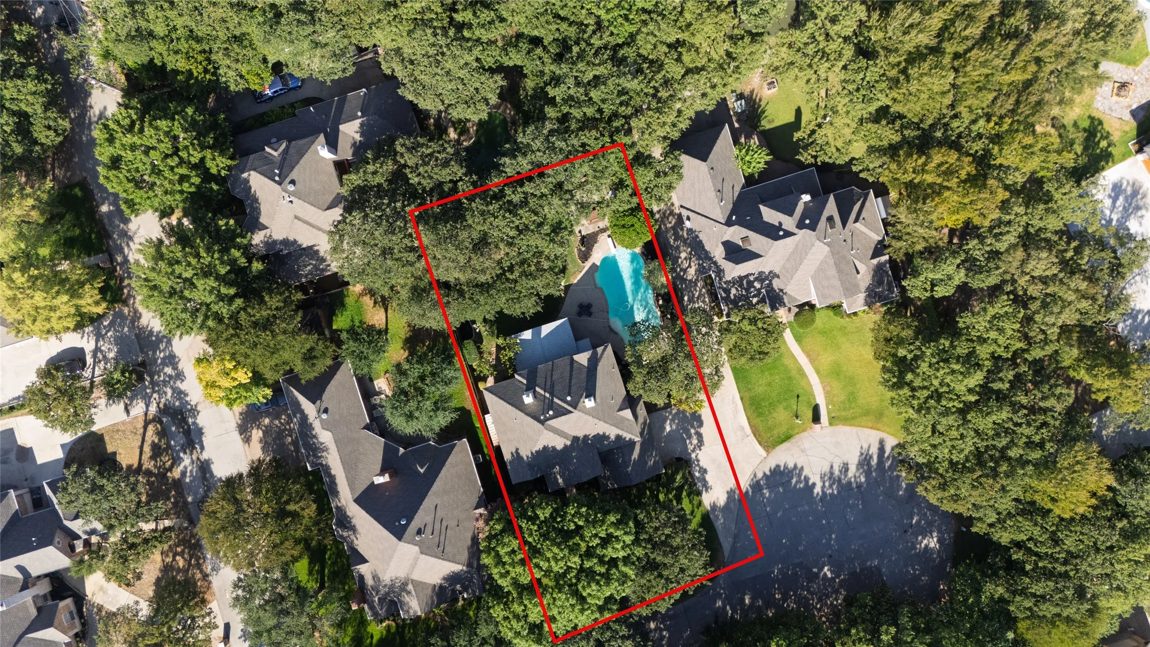 Expansive property featuring a large residence, mature tree coverage, a private swimming pool, and a circular driveway