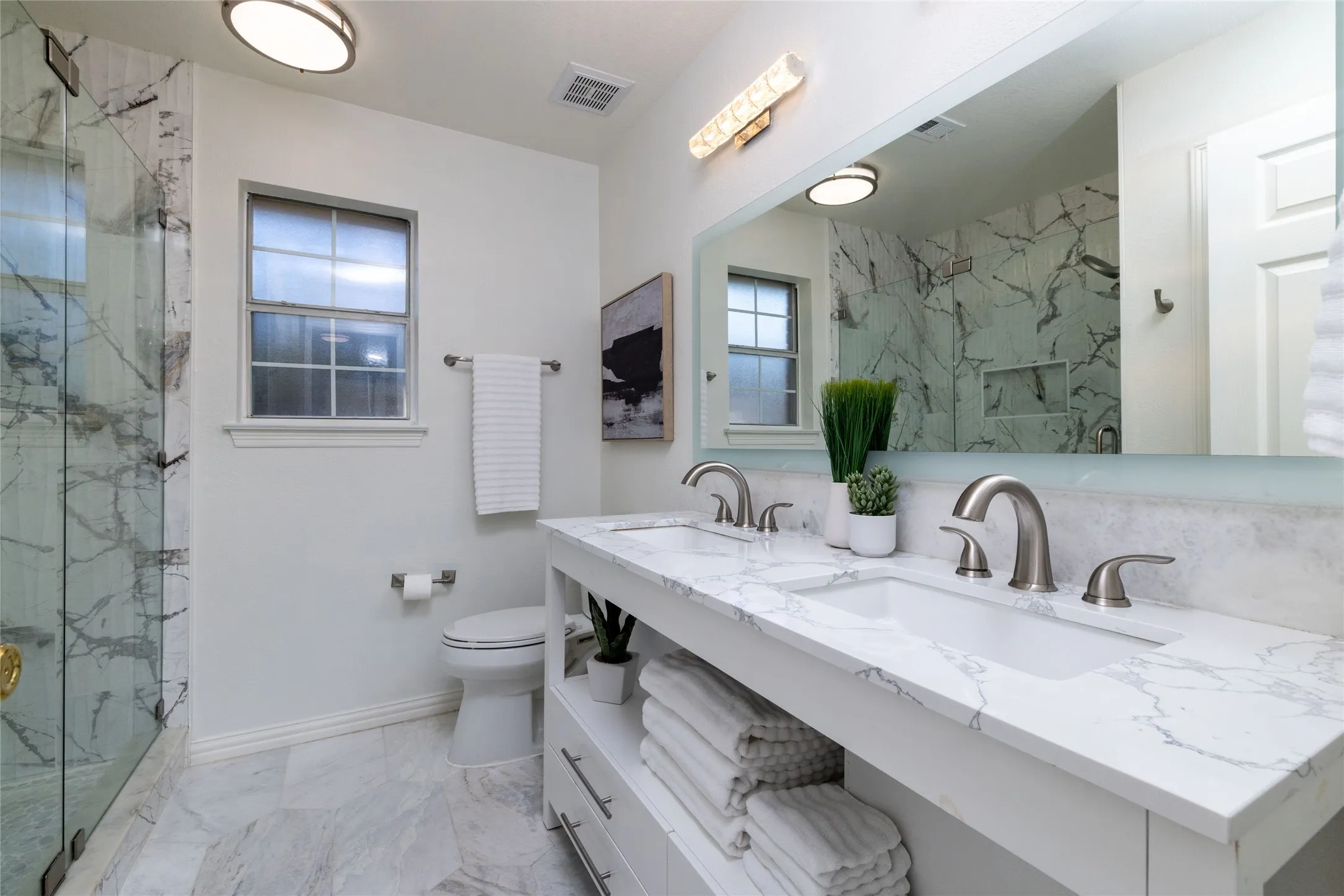 Dual vanity with white cabinetry and integrated sinks