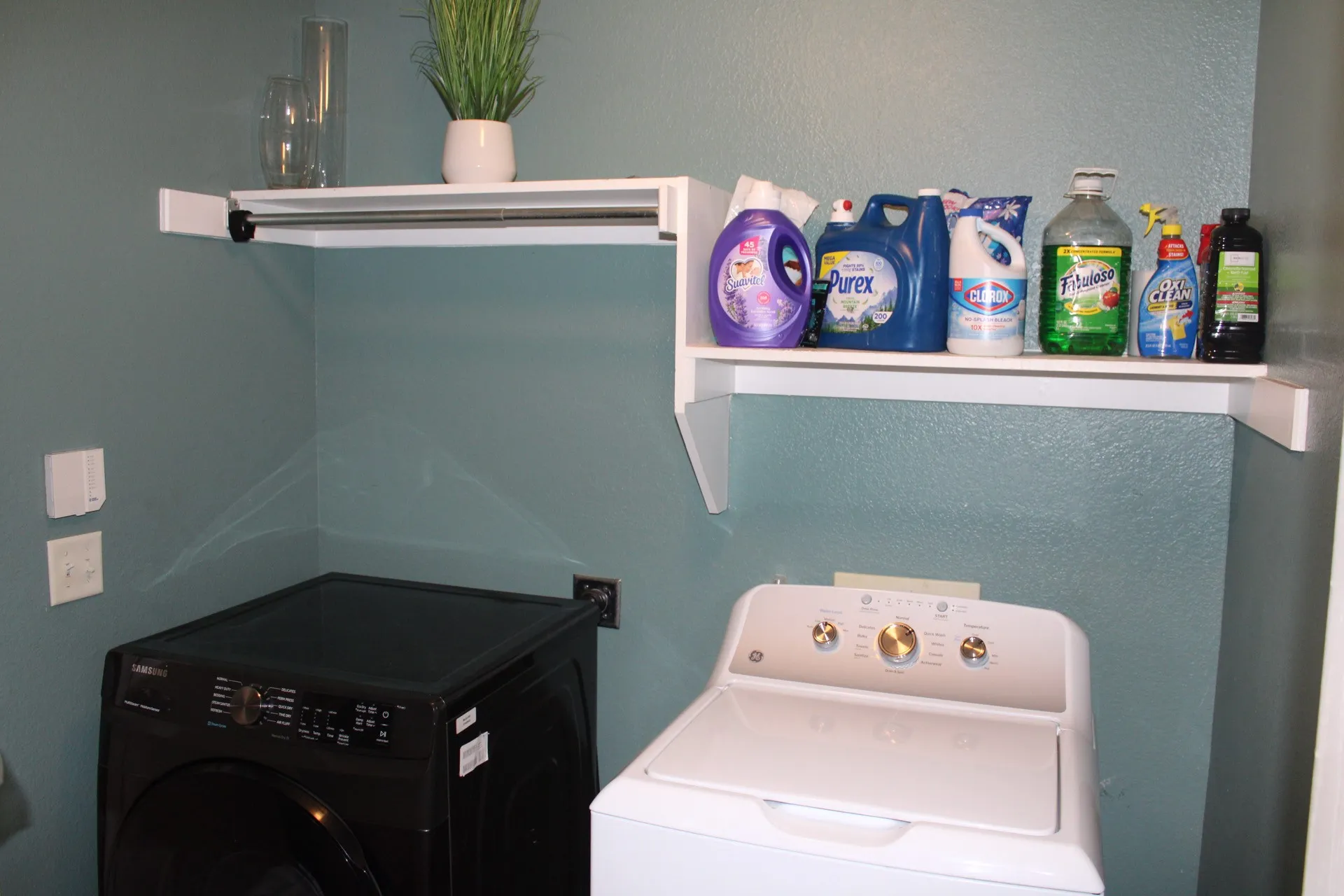 Built-in shelving and hanging rod provide organized storage