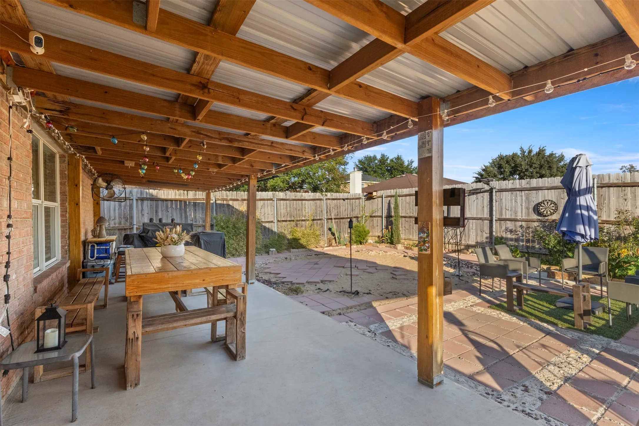 Covered patio with a wood beam ceiling and metal roof