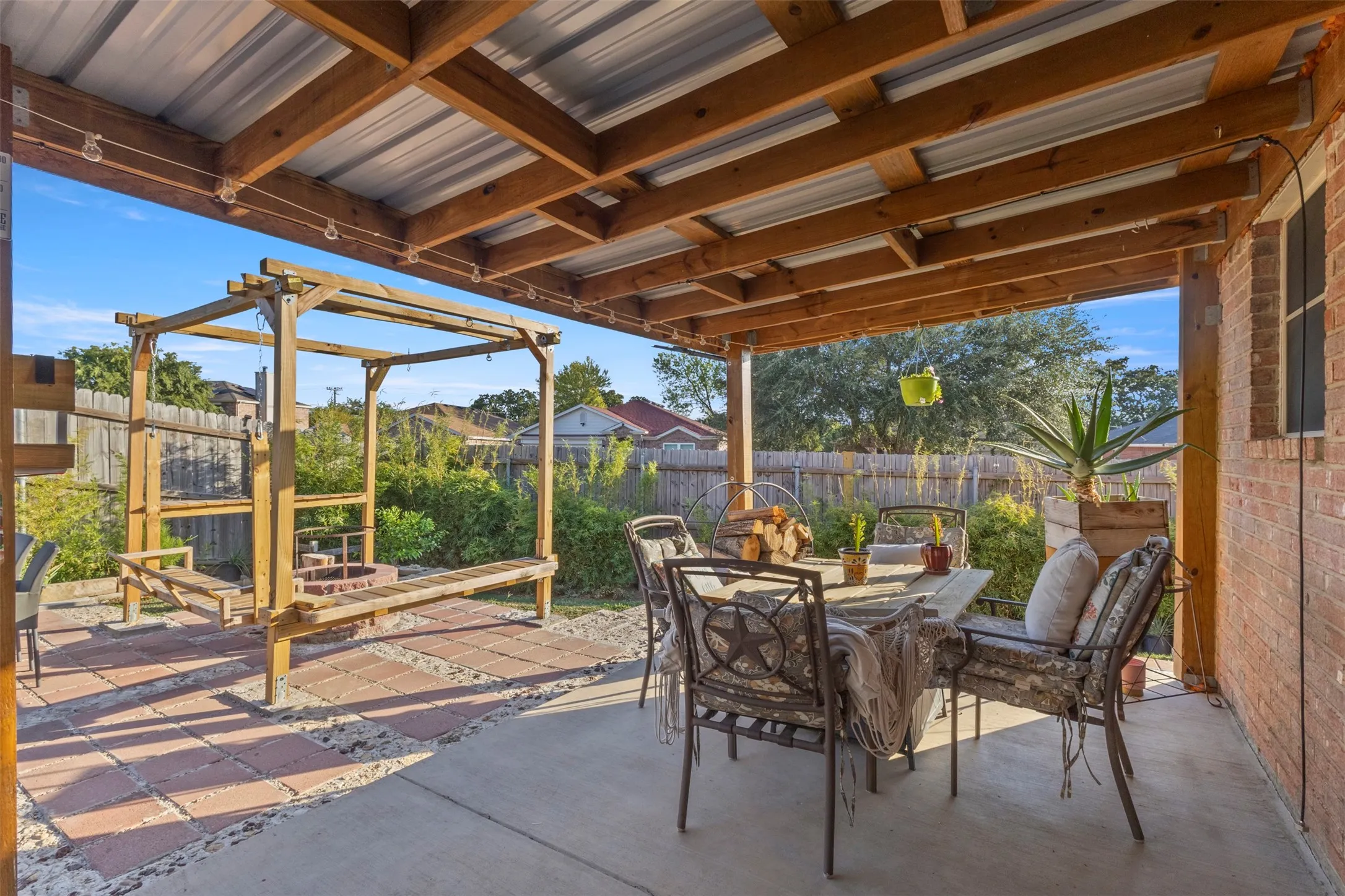 Covered patio with wood beam ceiling and corrugated metal roof